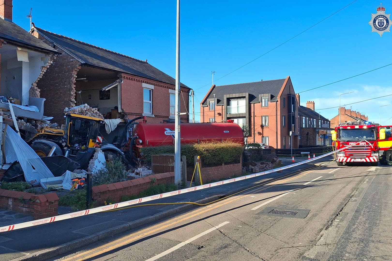 A tractor crashed into the front of two houses (Cheshire Constabulary/PA)