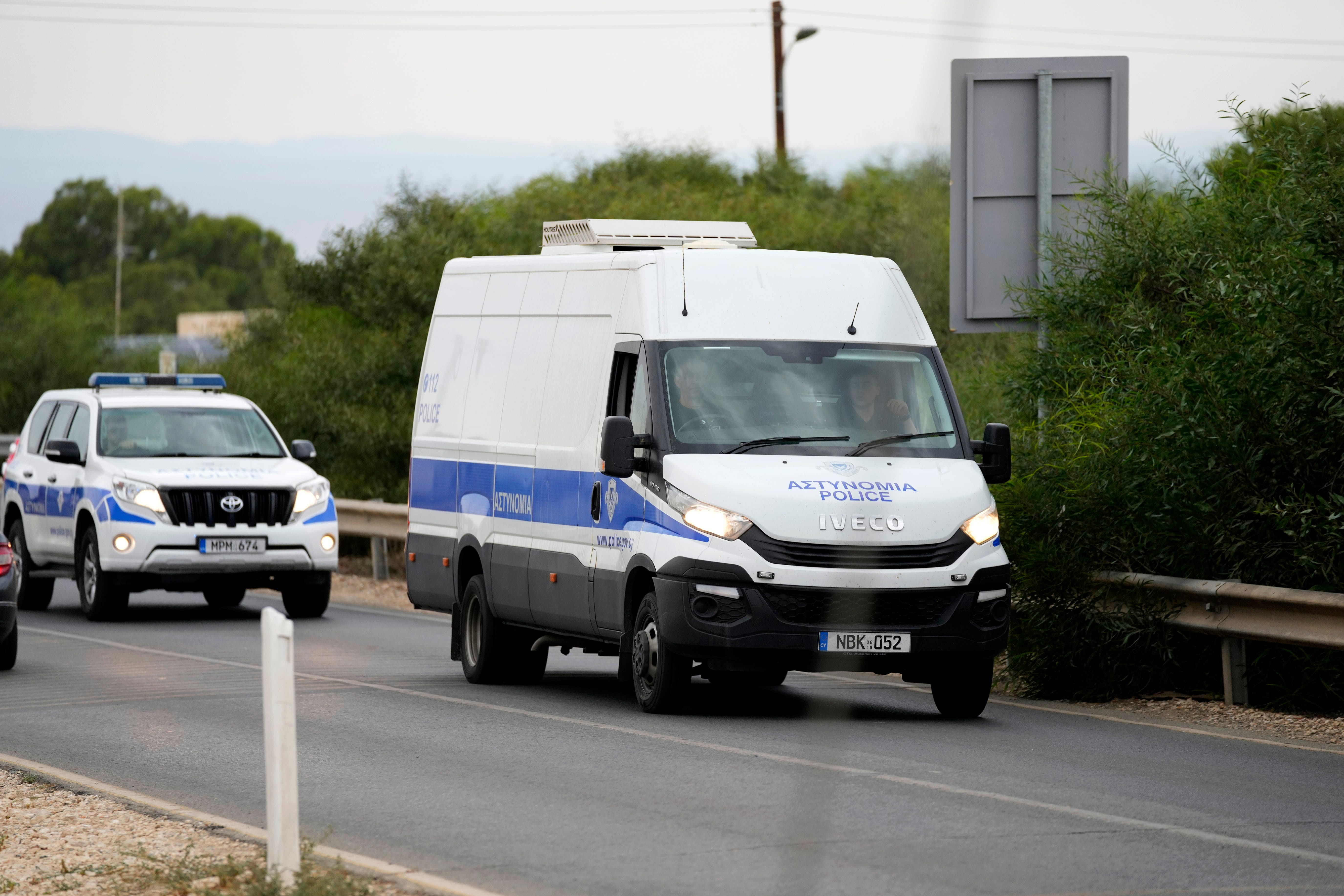 The police van carrying the five Israelis who are accused of raping a British woman (Petros Karadjias/AP)
