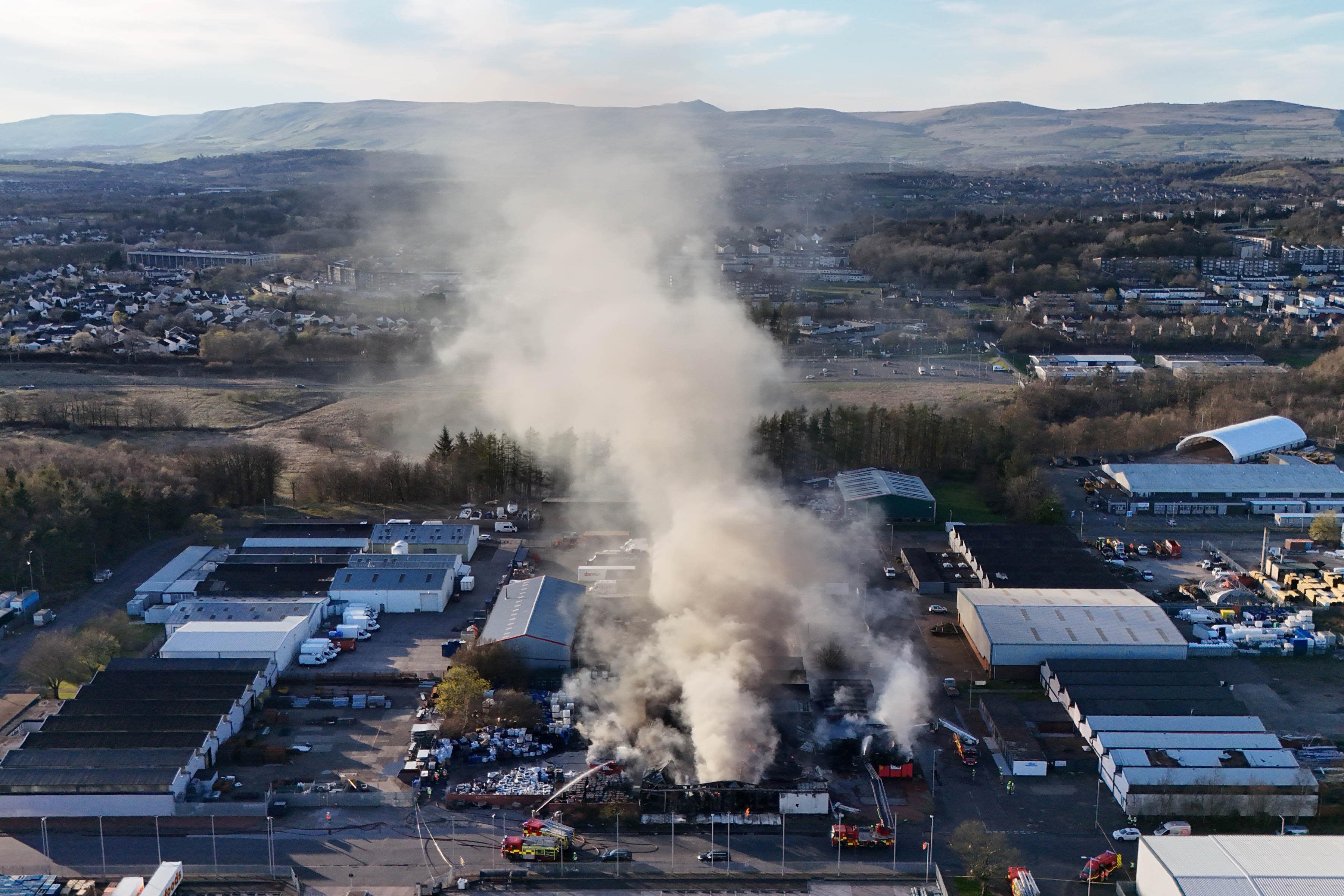 Fire fighters at the scene of a fire at an industrial unit in Broomlee Road, Cumbernauld, North Lanarkshire. A total of six fire engines were sent to Blairlinn Industrial Estate where a building was “well alight”, with six people treated by paramedics. Six ambulances and a trauma team and resuscitation unit were also sent to the scene. Picture date: Tuesday April 1, 2025. (Andrew Milligan/PA)