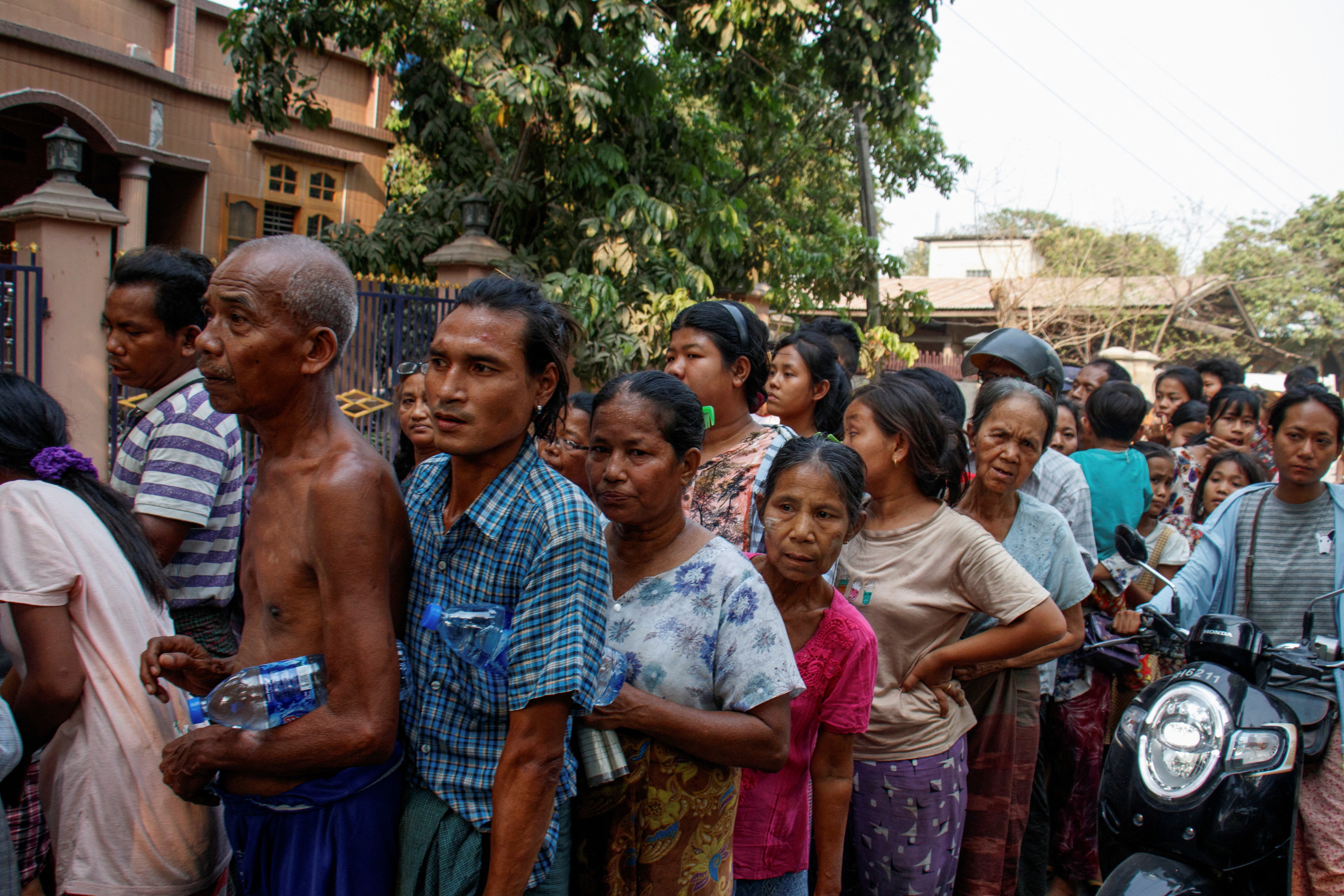 People queue for relief supplies after a strong earthquake near the earthquake's epicenter, in Sagaing, Myanmar