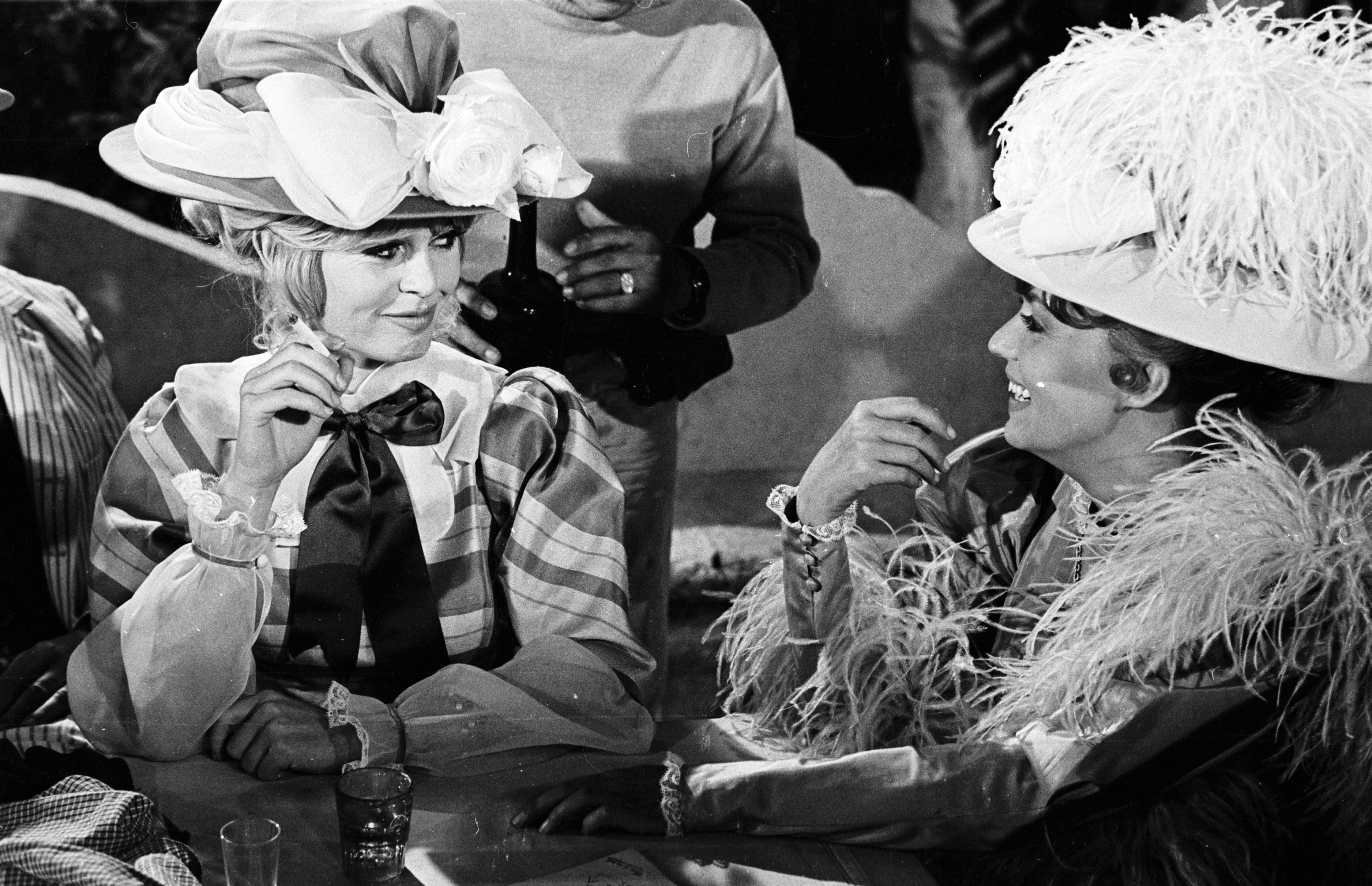 Iconic French actors Brigitte Bardot and Jeanne Moreau relaxing between shots while filming Viva Maria in 1965