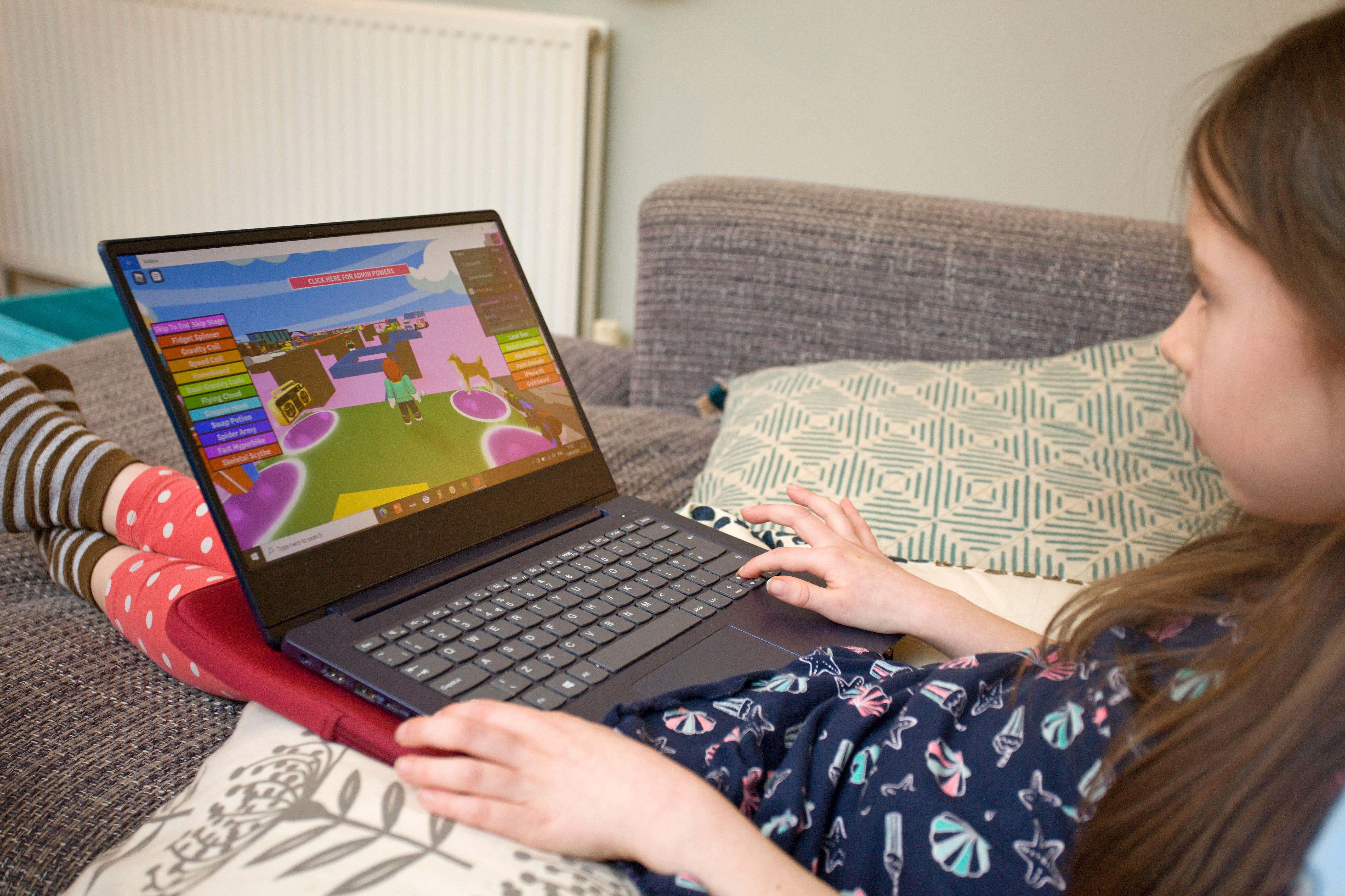 Young girl playing Roblox on laptop computer (tom viggars/Alamy/PA)