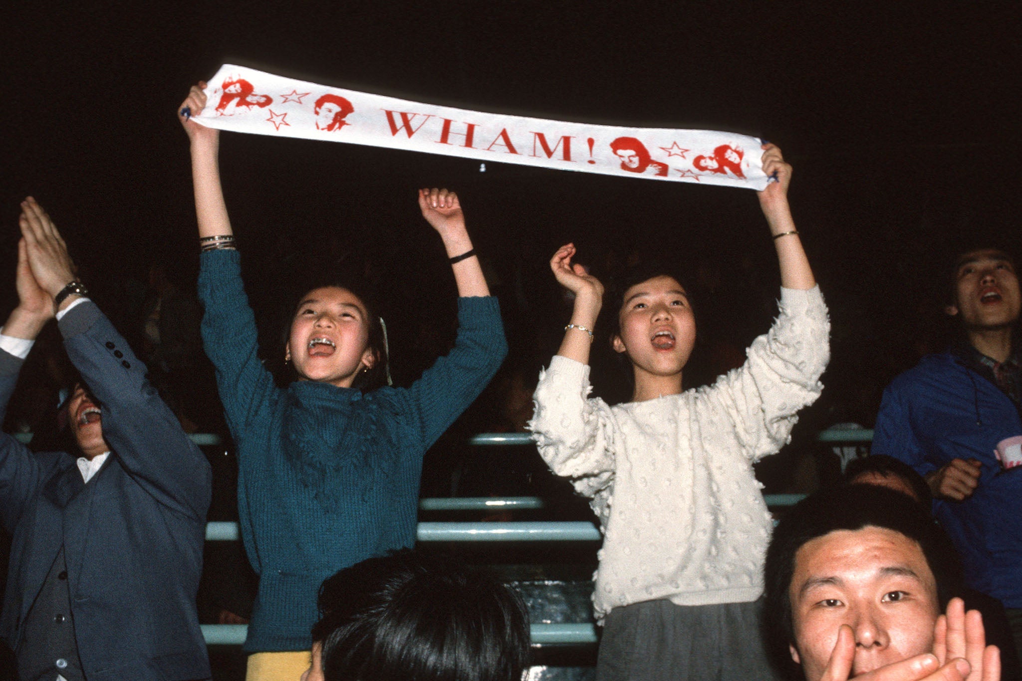 Fans dance in the aisle at Wham!’s concert in Beijing, which marked the first Western pop band performance in communist China