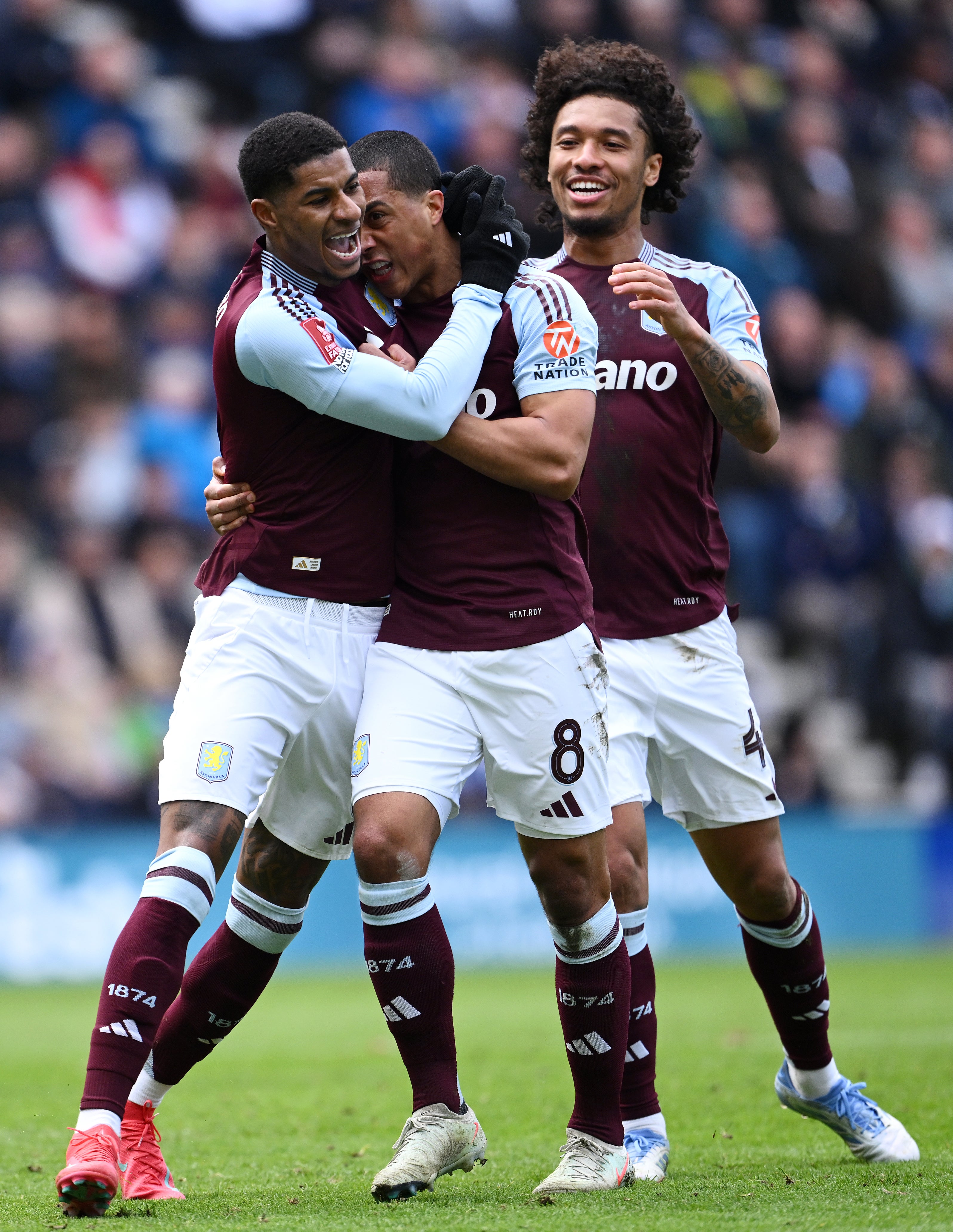 Marcus Rashford of Aston Villa celebrates scoring his team's second goal from the penalty spot with Youri Tielemans and Boubacar Kamara