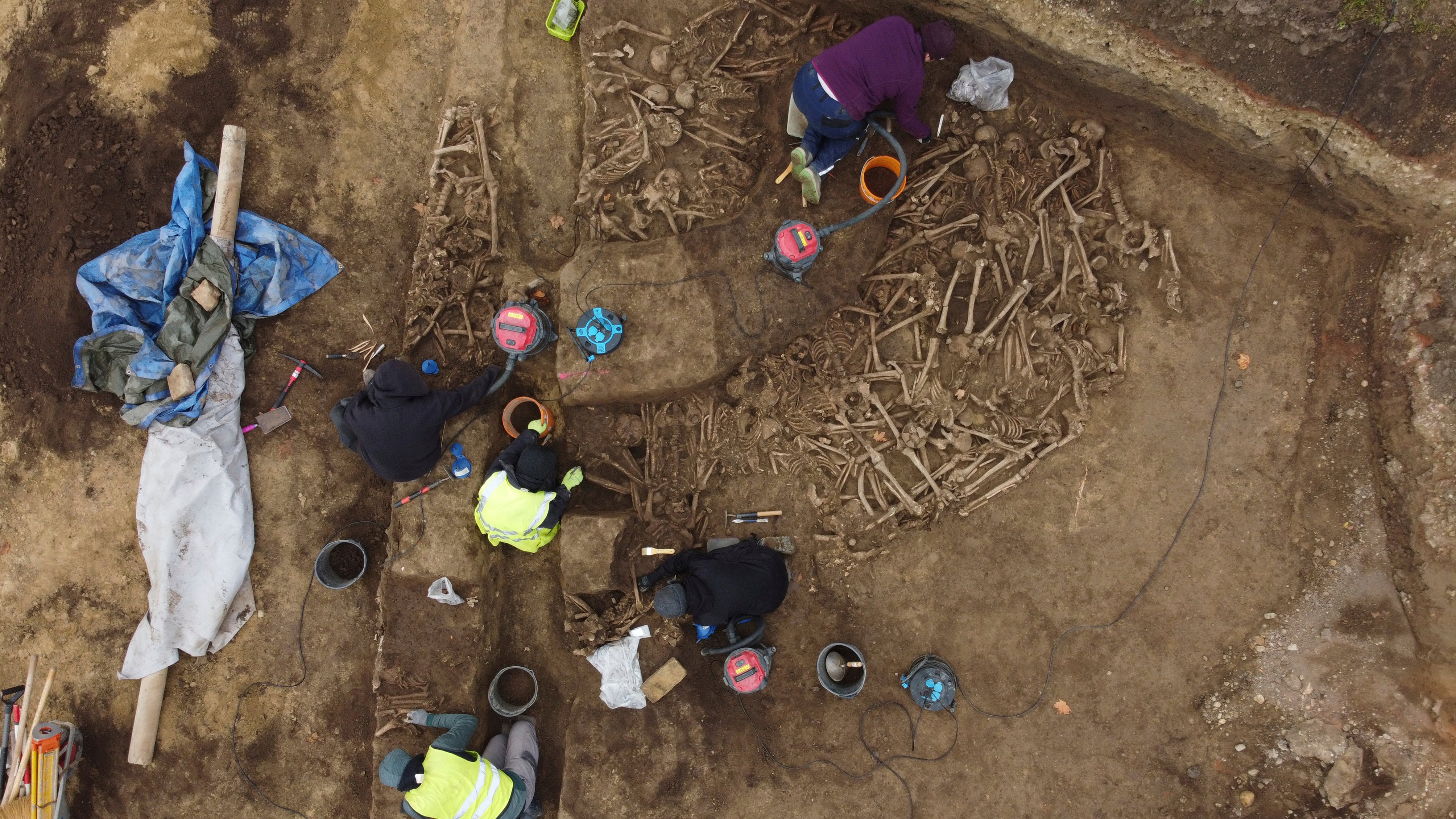 Archaeologists work at a newly discovered mass grave in Vienna, Austria