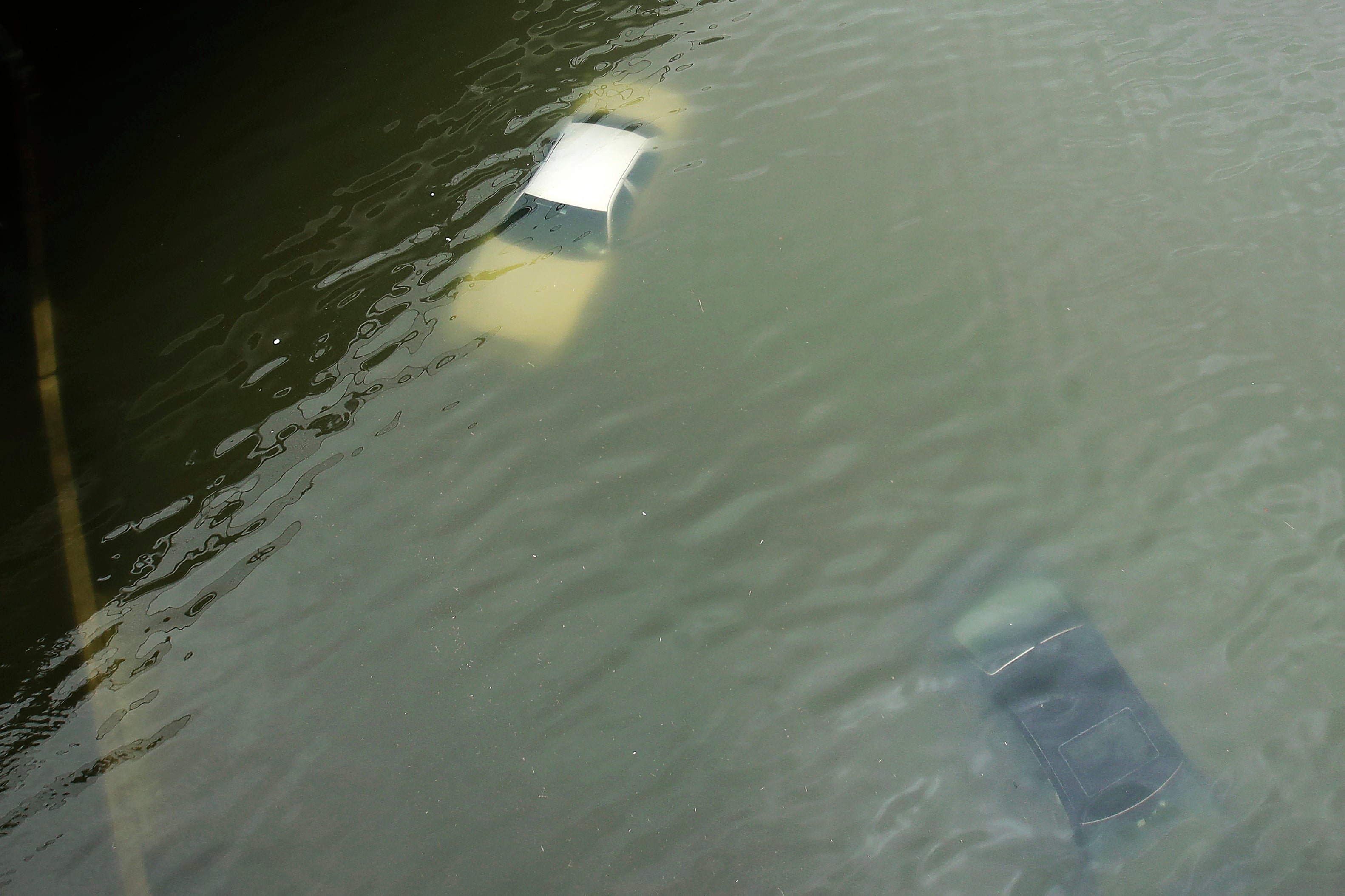 Cars are submerged on a freeway flooded in the aftermath of Hurricane Harvey near downtown Houston, Texas, on Aug. 27, 2017.