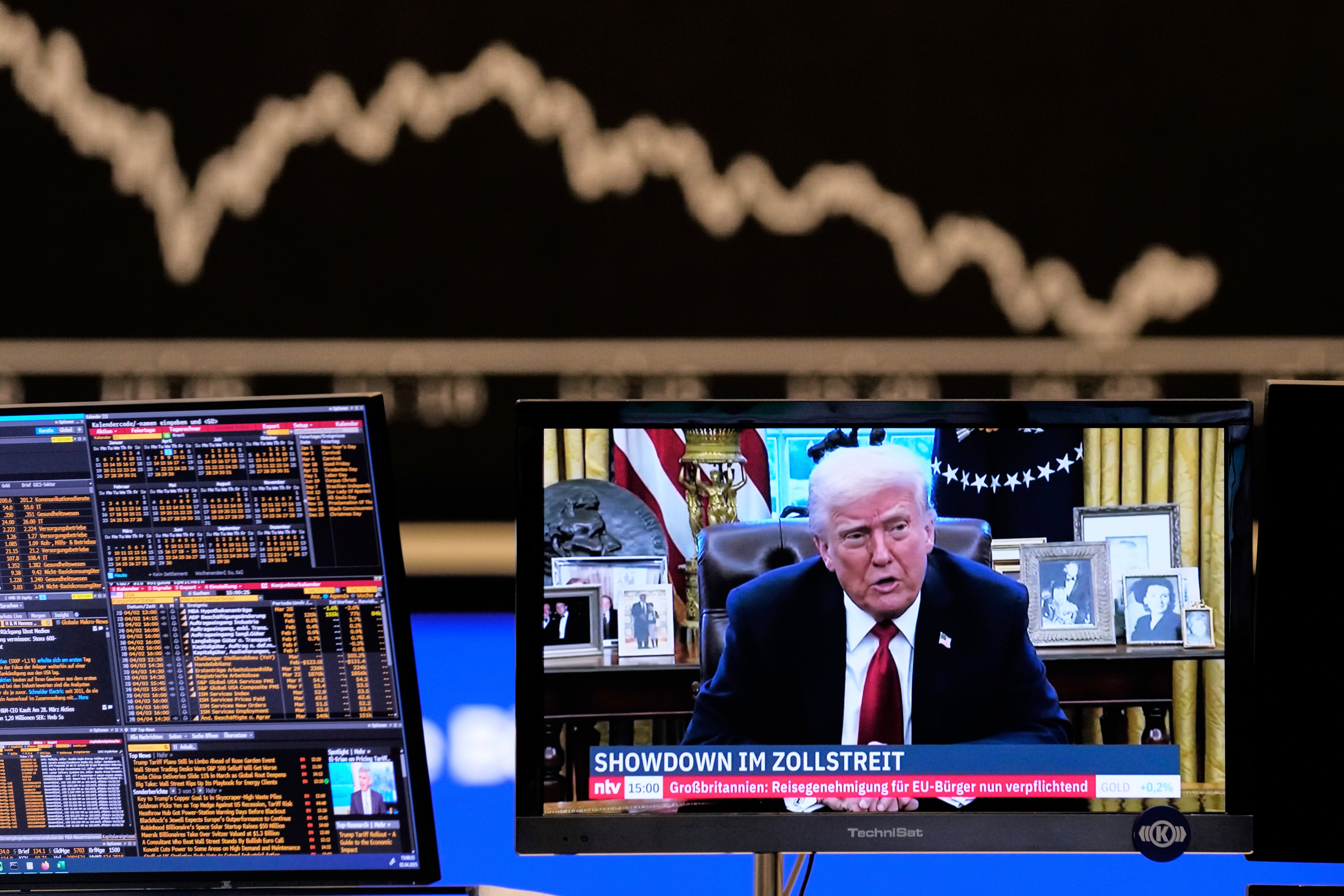 US President Donald Trump appears on a television screen at the stock market in Frankfurt, Germany