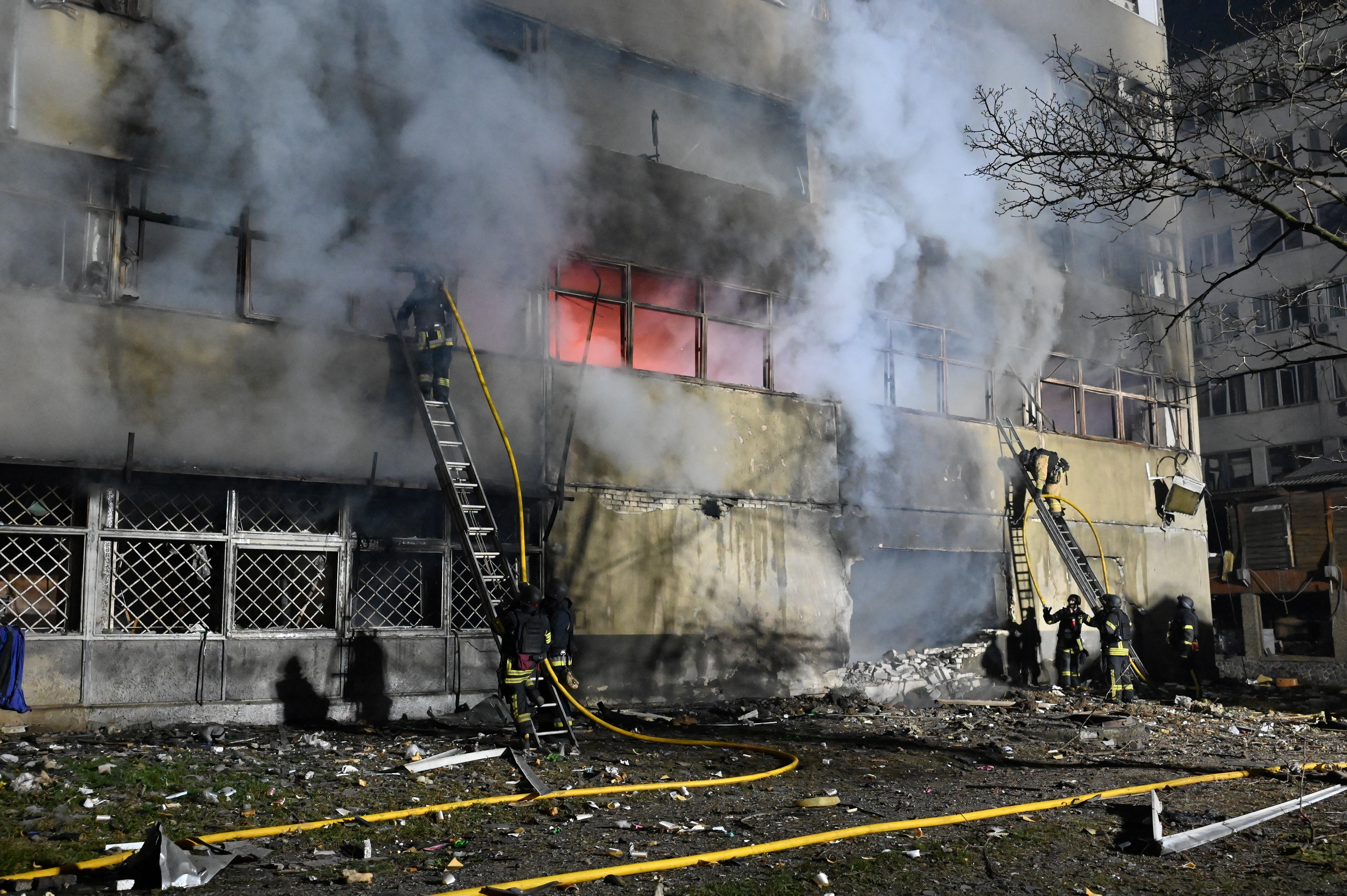 Firefighters at a civilian enterprise following a drone attack in Kharkiv
