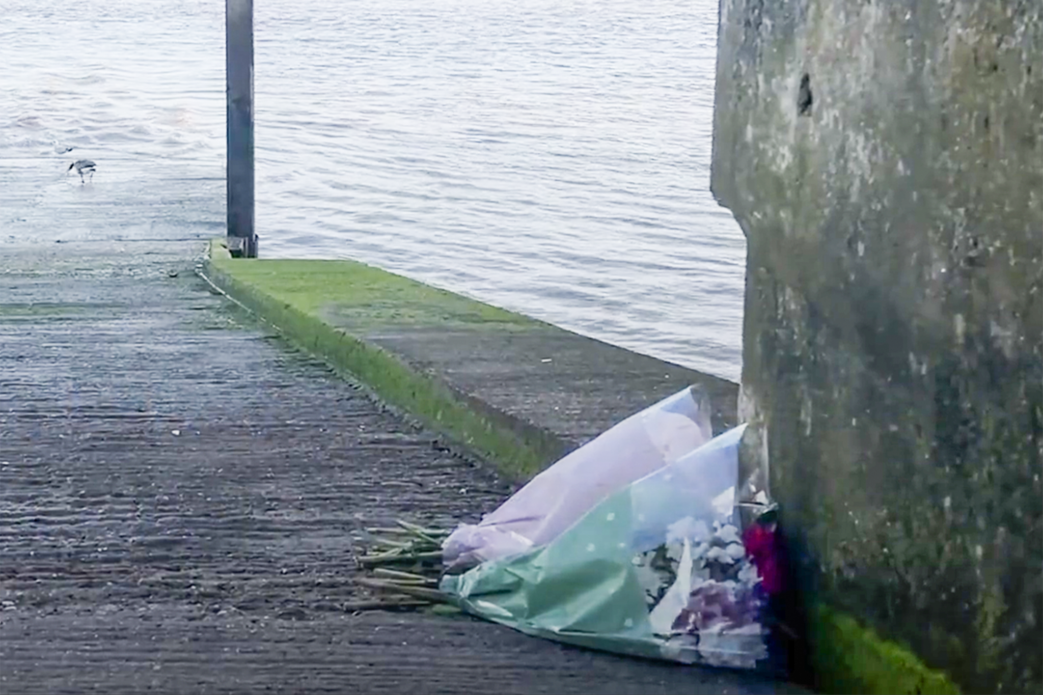Flowers left at the Barge House Causeway
