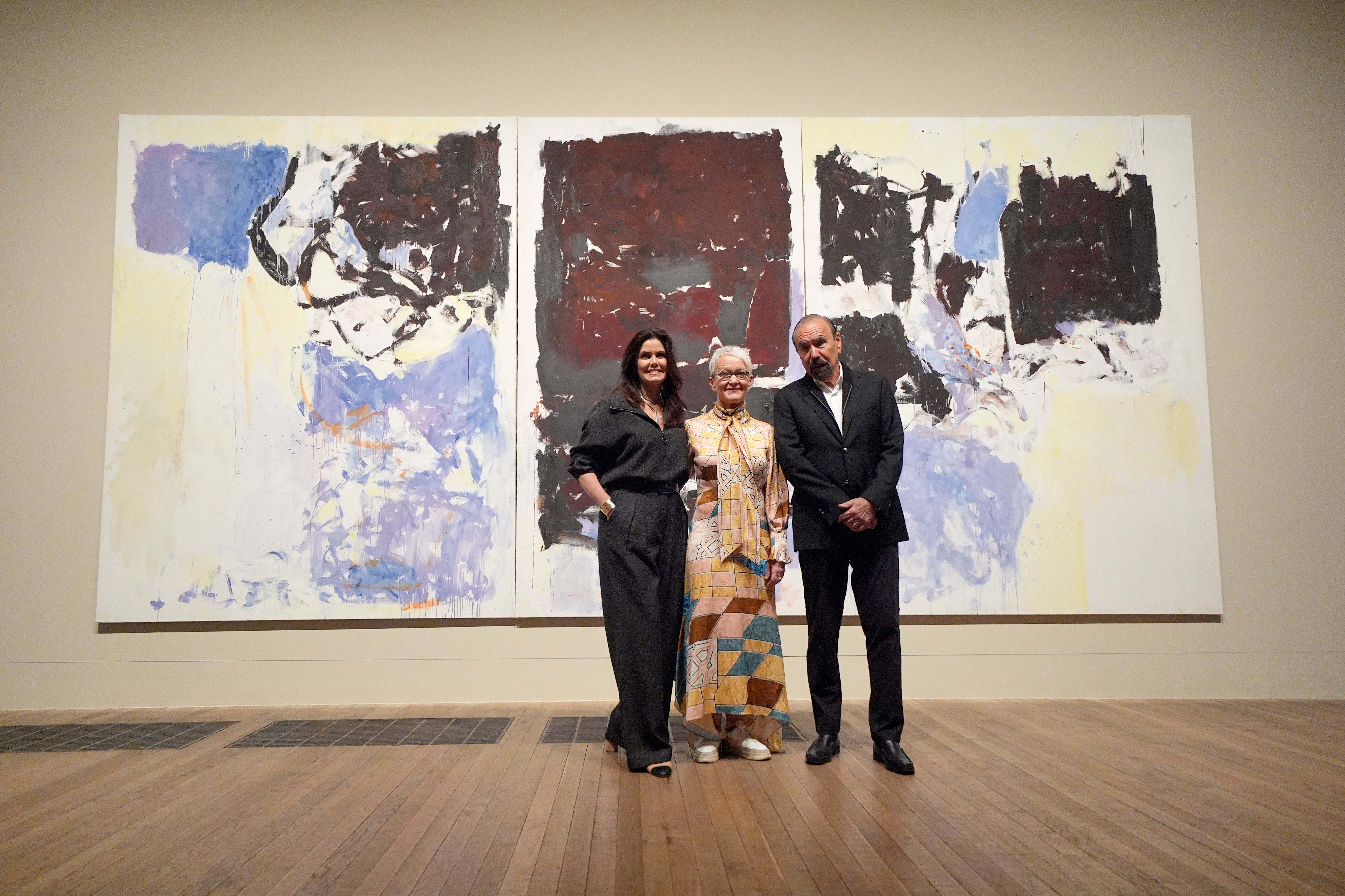 Darlene Pérez, Jorge M. Pérez and Tate director Maria Balshaw in front of 'Iva' by Joan Mitchell