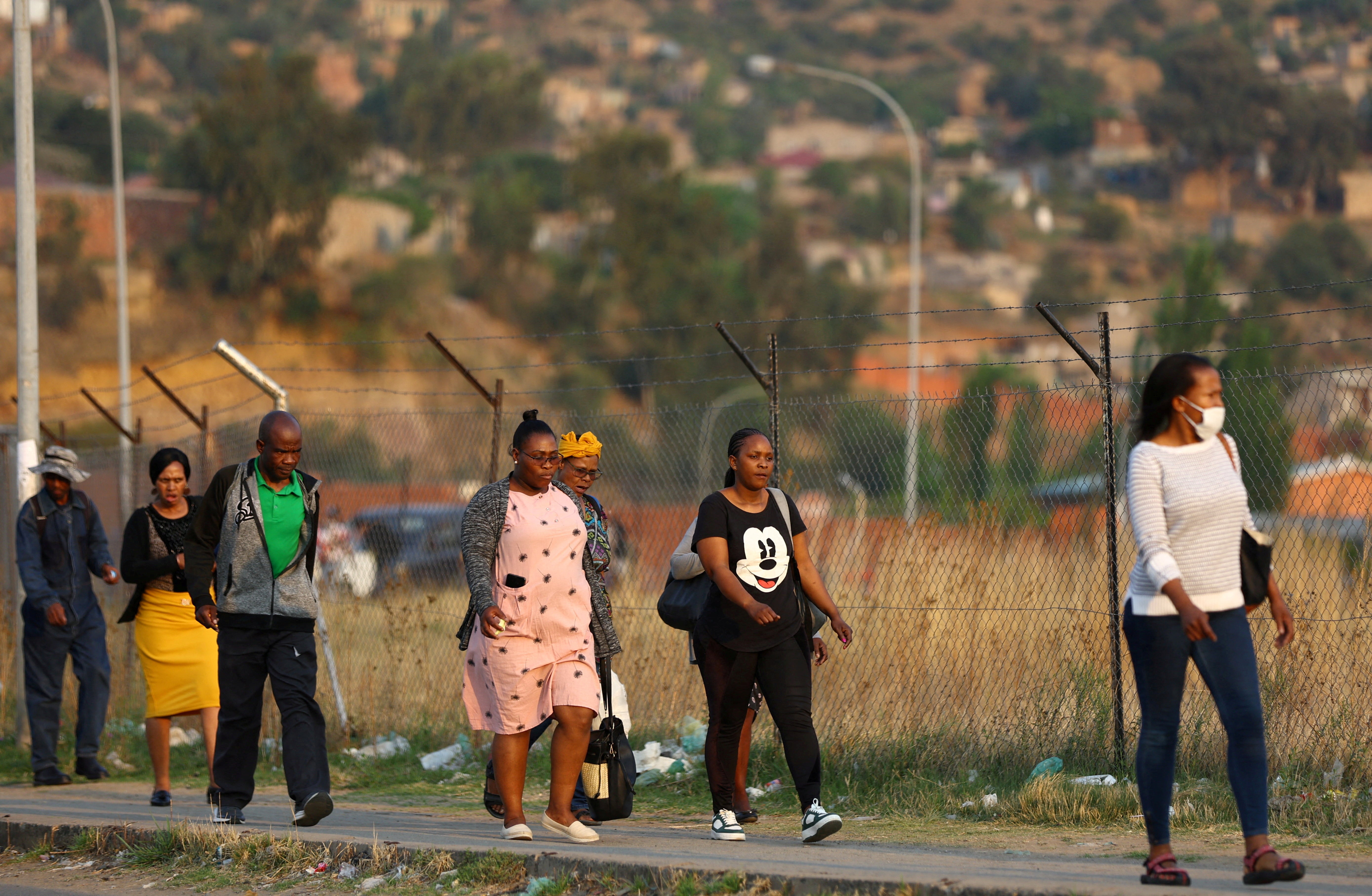 Factory workers walk home after work outside the capital Maseru in Lesotho