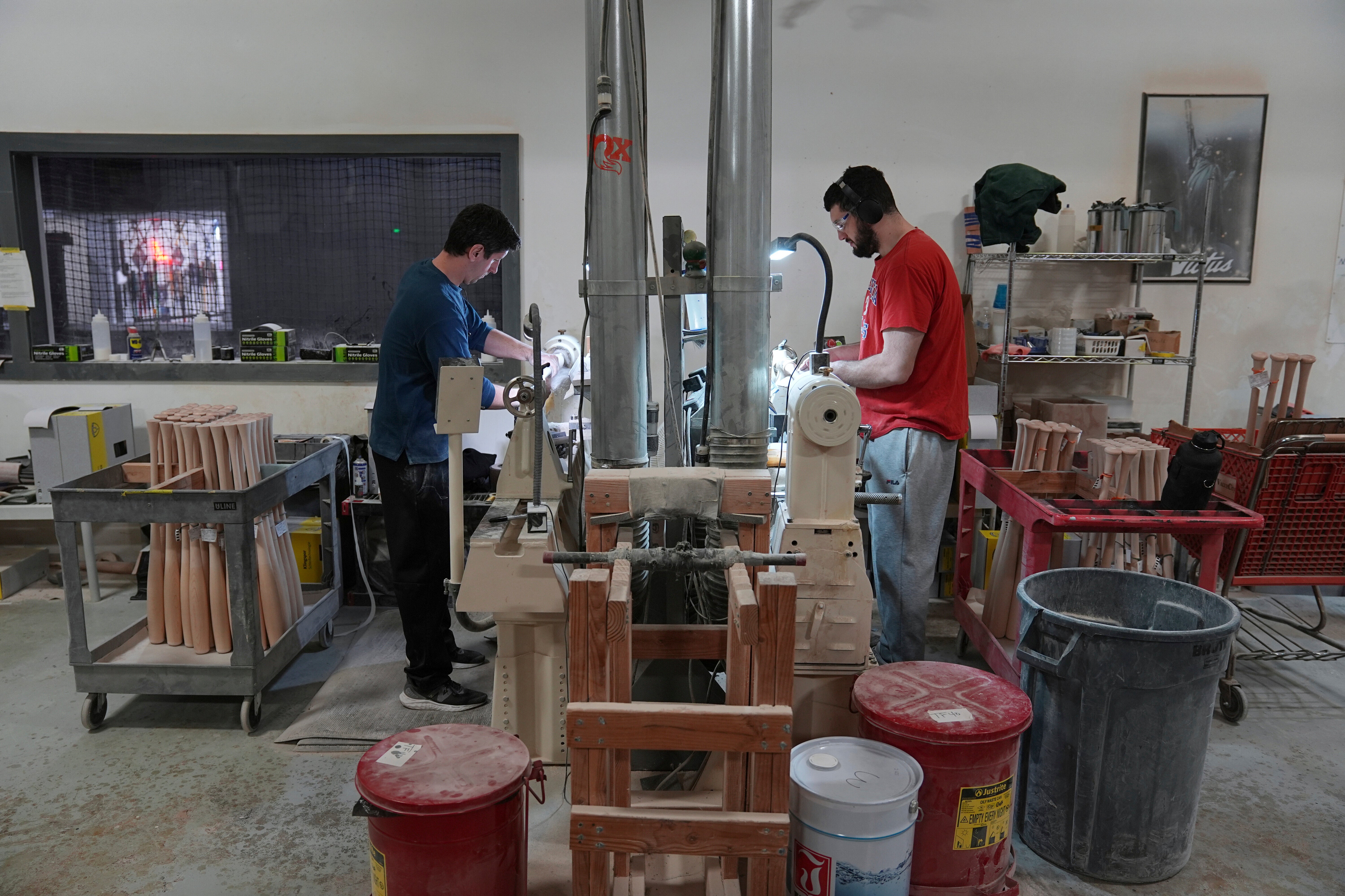 Jim Levasseur, left, and Joseph D'Emilio manufacture torpedo baseball bats at Victus Sports