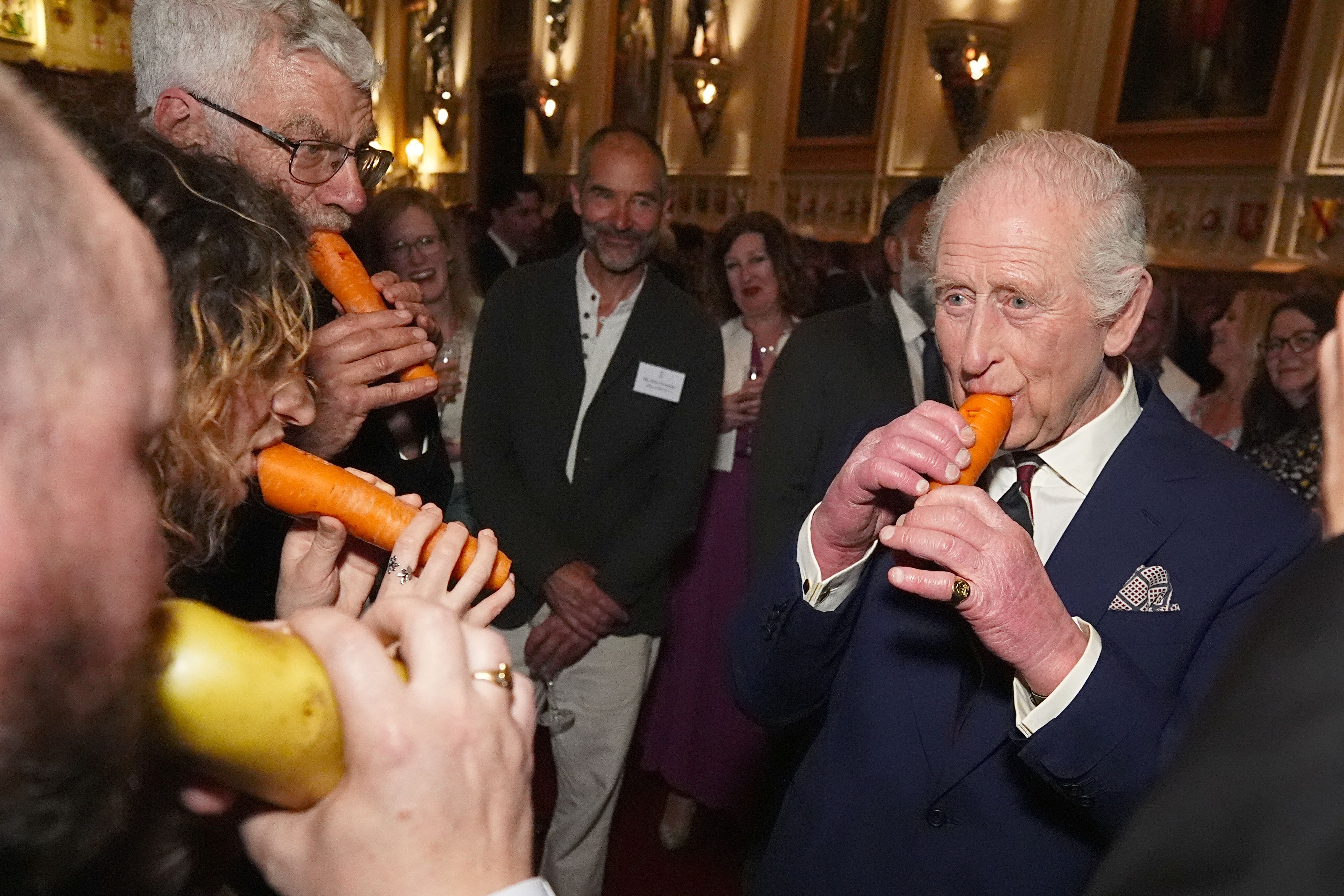The King plays a carrot with the London Vegetable Orchestra (Aaron Chown/PA)