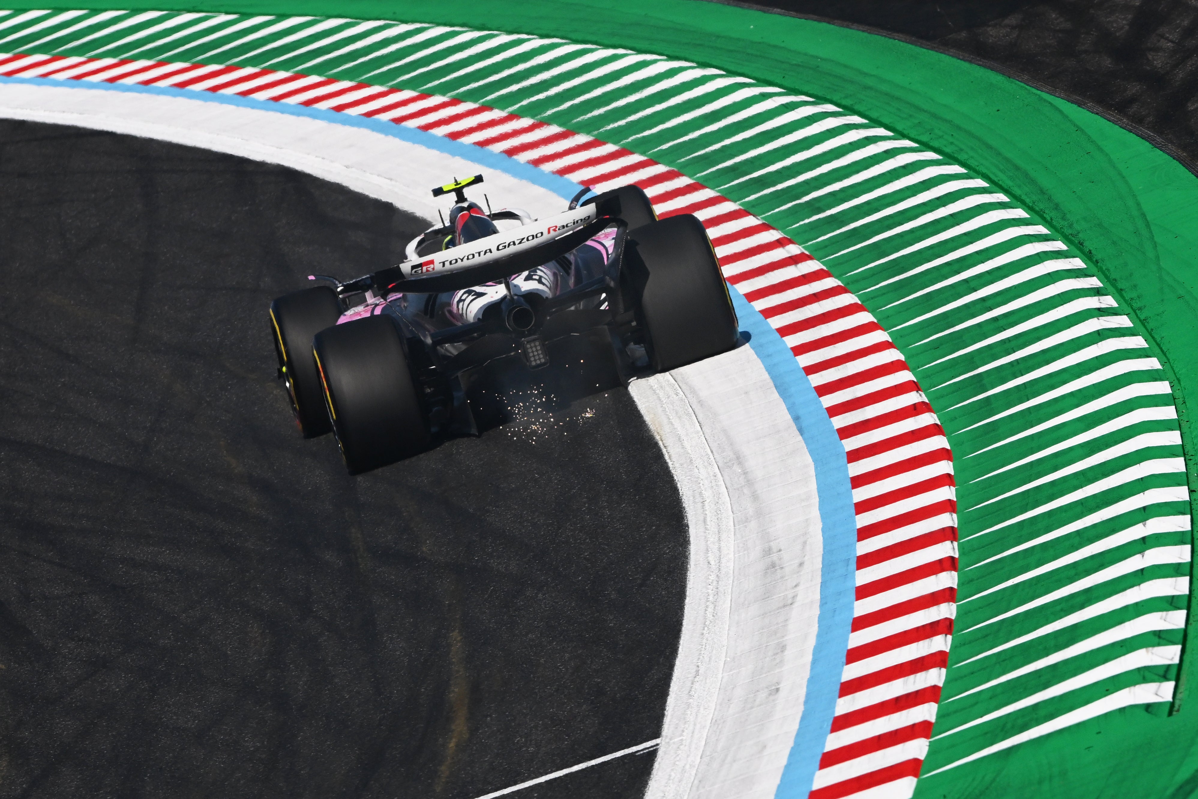 Sparks from the rear-underside of the cars were blown onto nearby grass