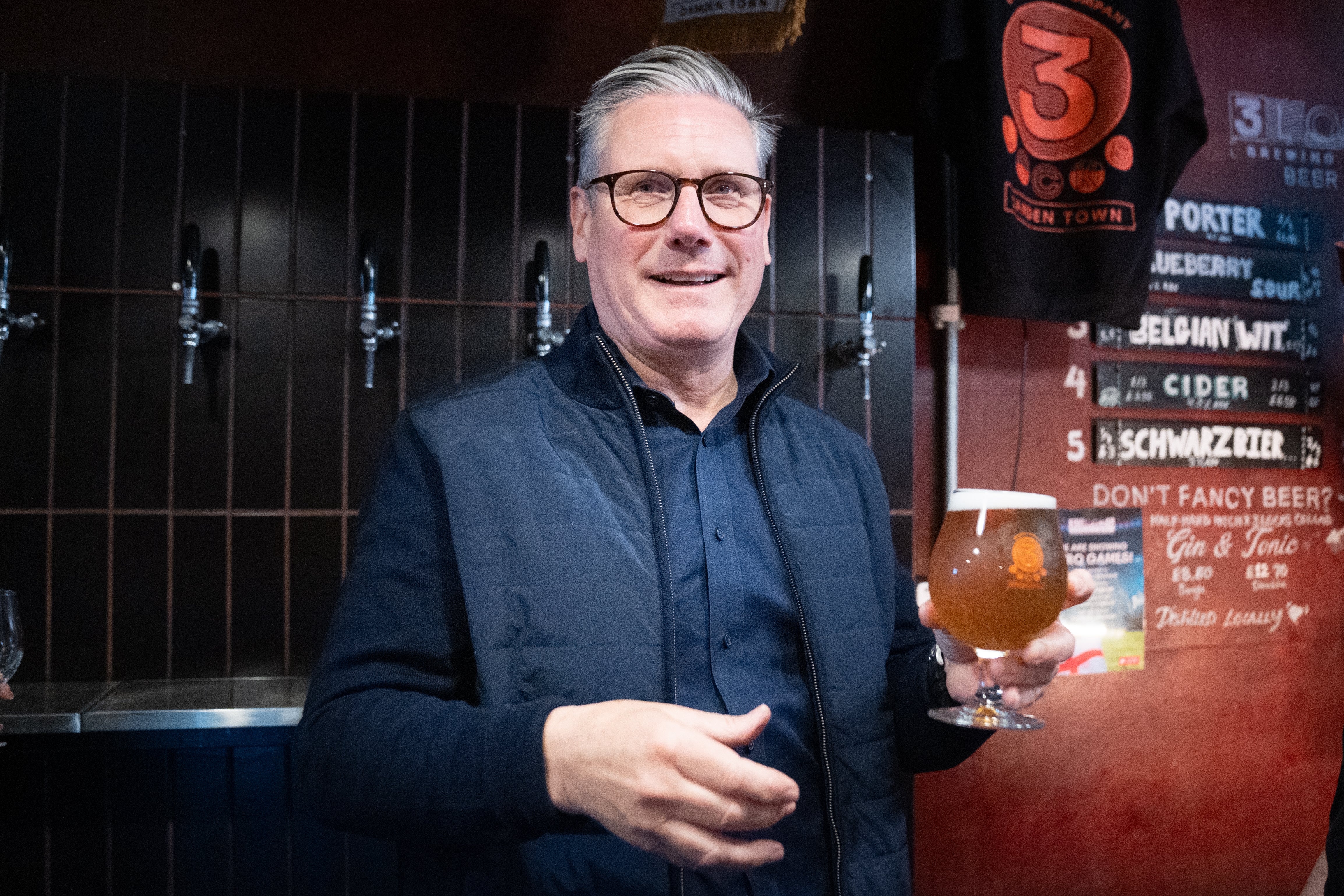 Labour Party leader Sir Keir Starmer helps to serve drinks during a visit to 3 Lock's Brewery in Camden in north London, where he launched Labour's plan for small businesses. Saturday June 8, 2024.