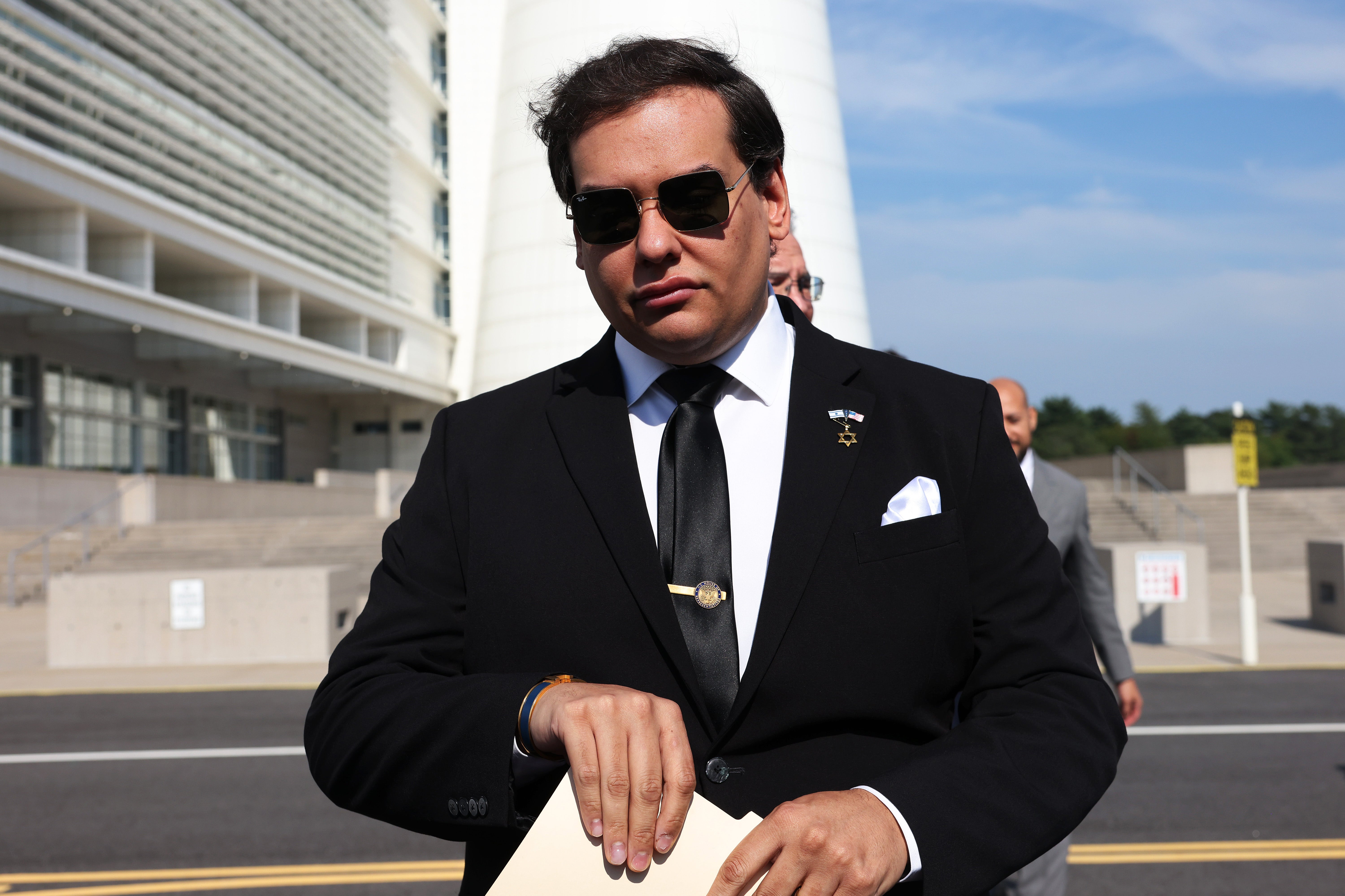 Former New York Republican Rep. George Santos prepares to give a statement after a court hearing last August in West Islip, New York. The government is arguing for an 87-month sentence