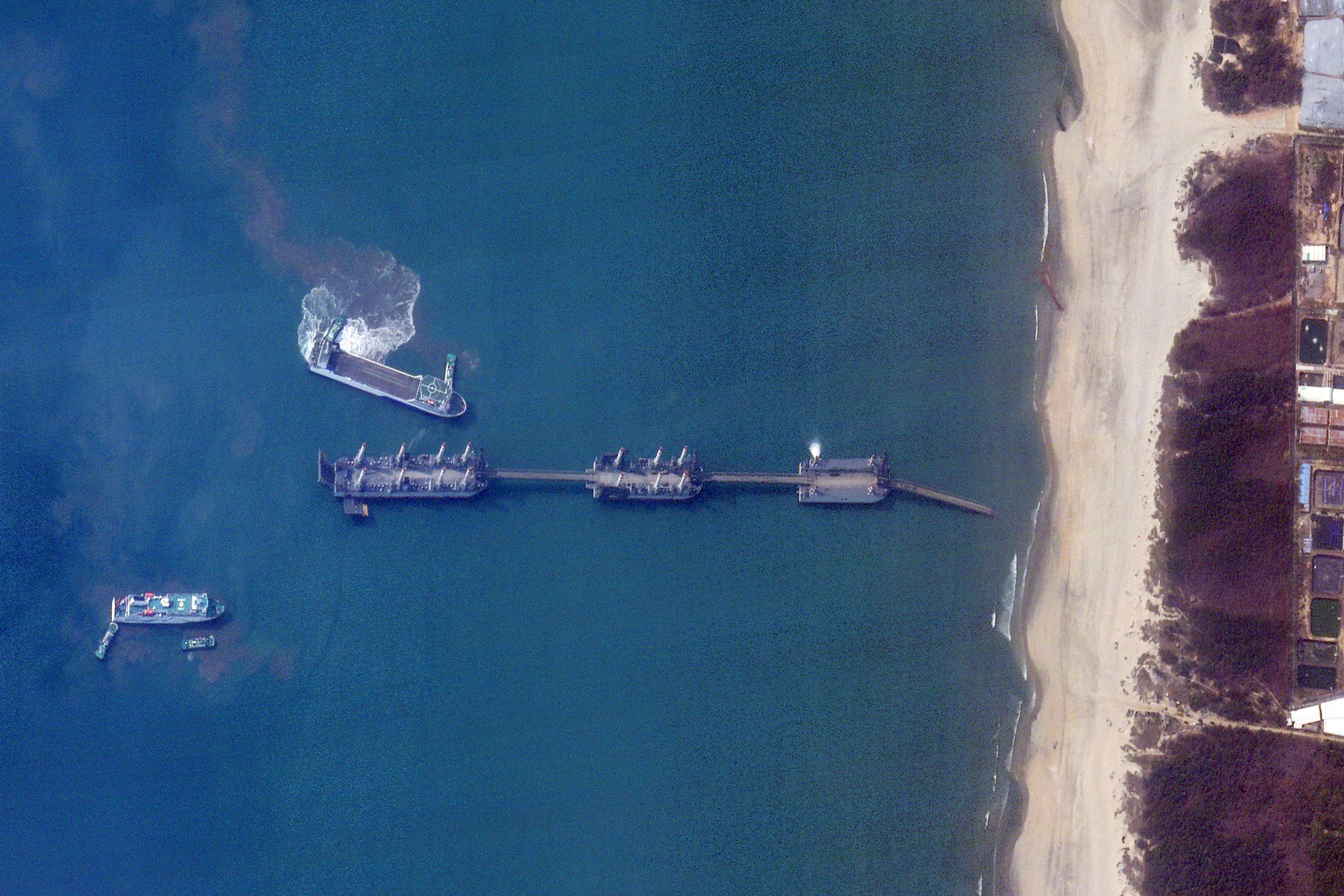 This satellite image taken on March 25, 2025 and received on April 3, 2025 by Planet Labs PBC shows three Chinese barges connected via extendable bridges in waters off Zhanjiang city, in southern China's Guangdong province