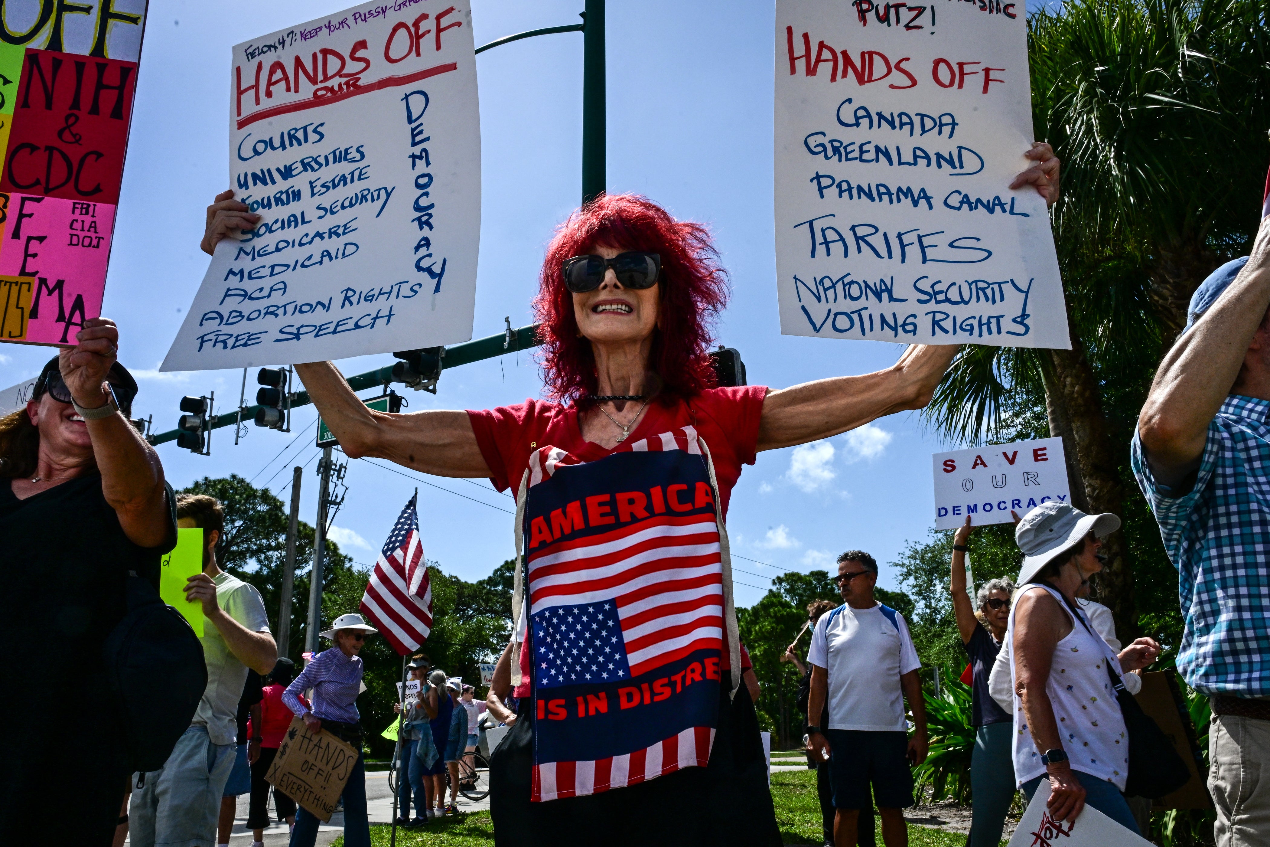 Demonstrators gathered in West Palm Beach, Florida in protest of Trump as the president golfed in the state Saturday