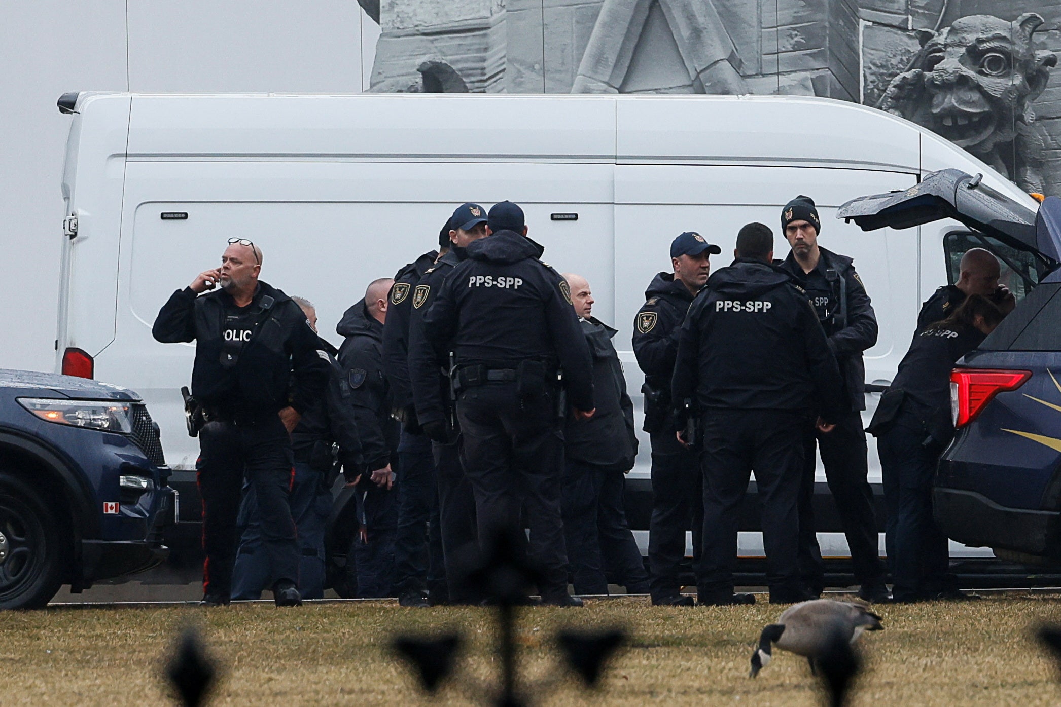 Canadian Parliamentary Protective Service officers outside the parliament building. A man was later taken into custody