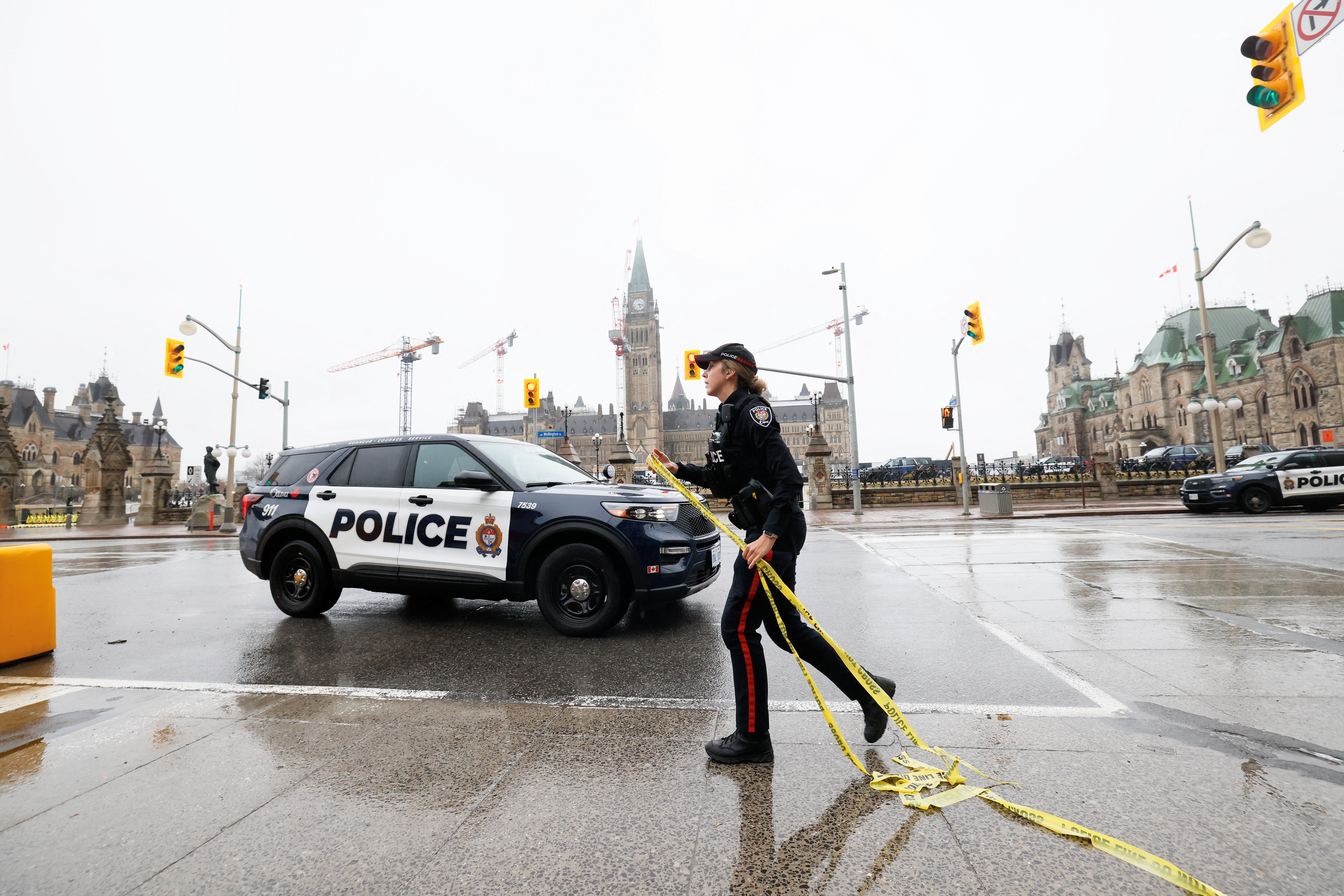 A police officer secures the perimeter of Canada's Parliament after declaring a lockdown, in Ottawa