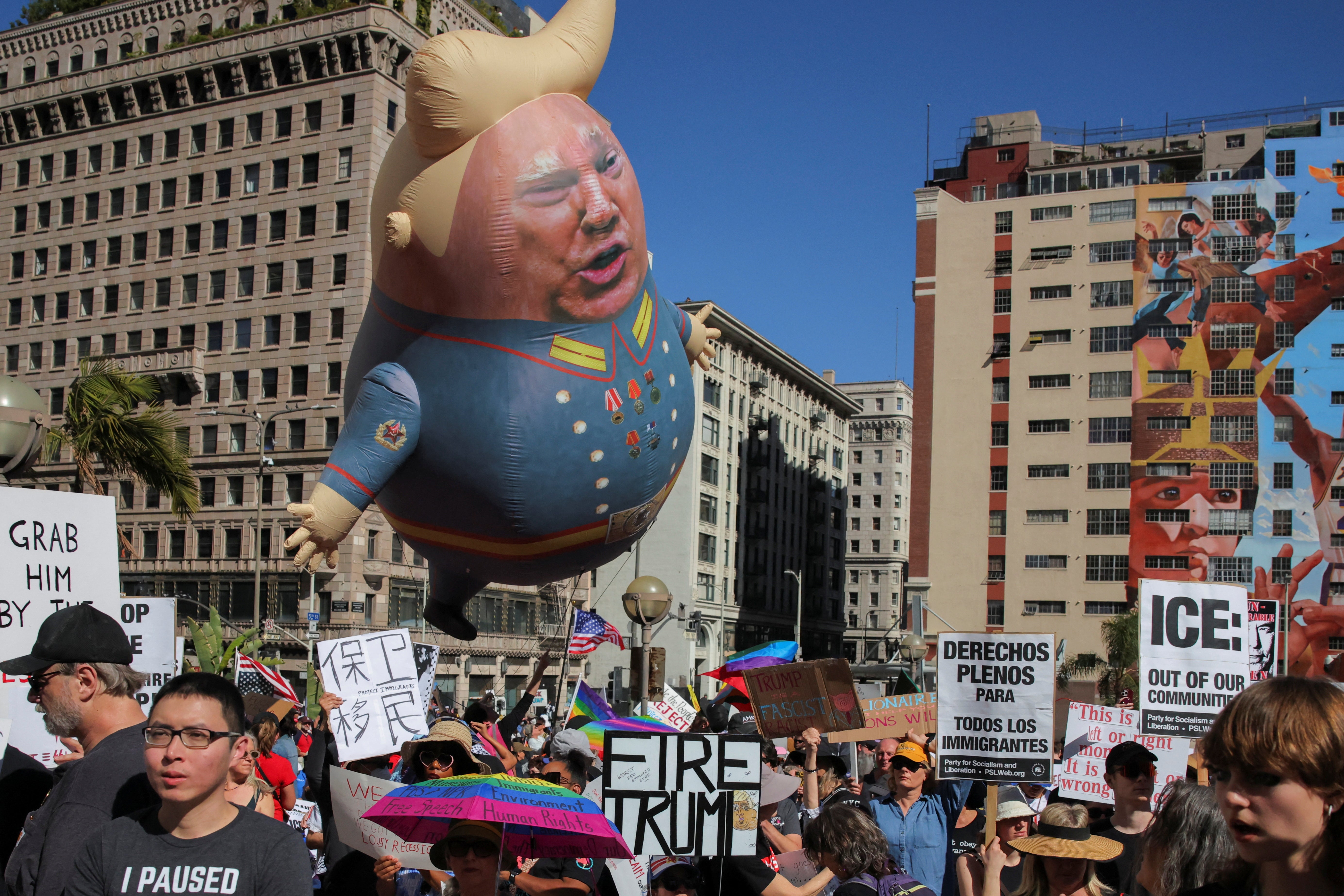 A blimp portraying Trump as a Confederate general flies above protesters in downtown Los Angeles