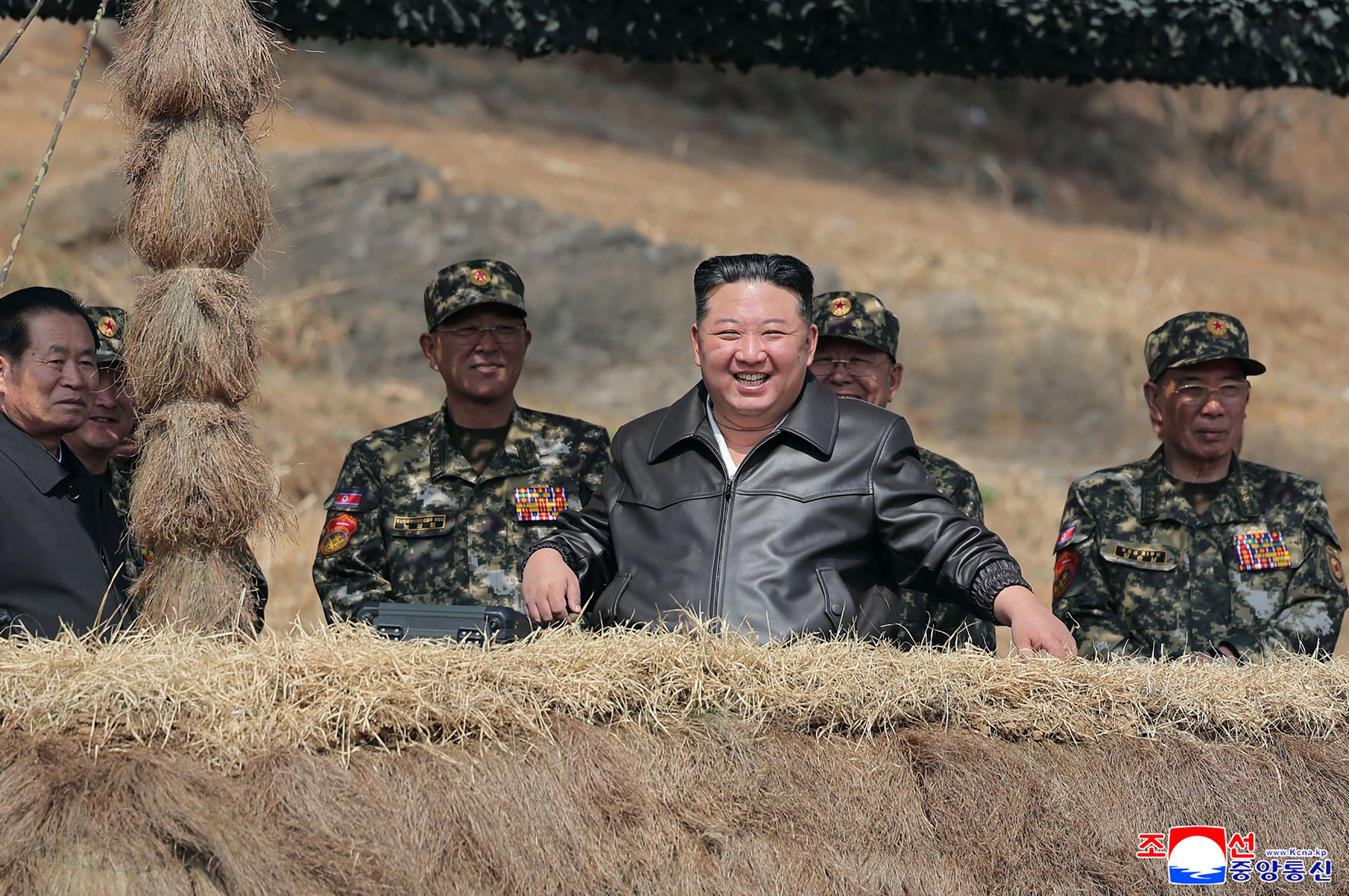 Kim Jong Un laughs as he observes a comprehensive training session at an undisclosed location