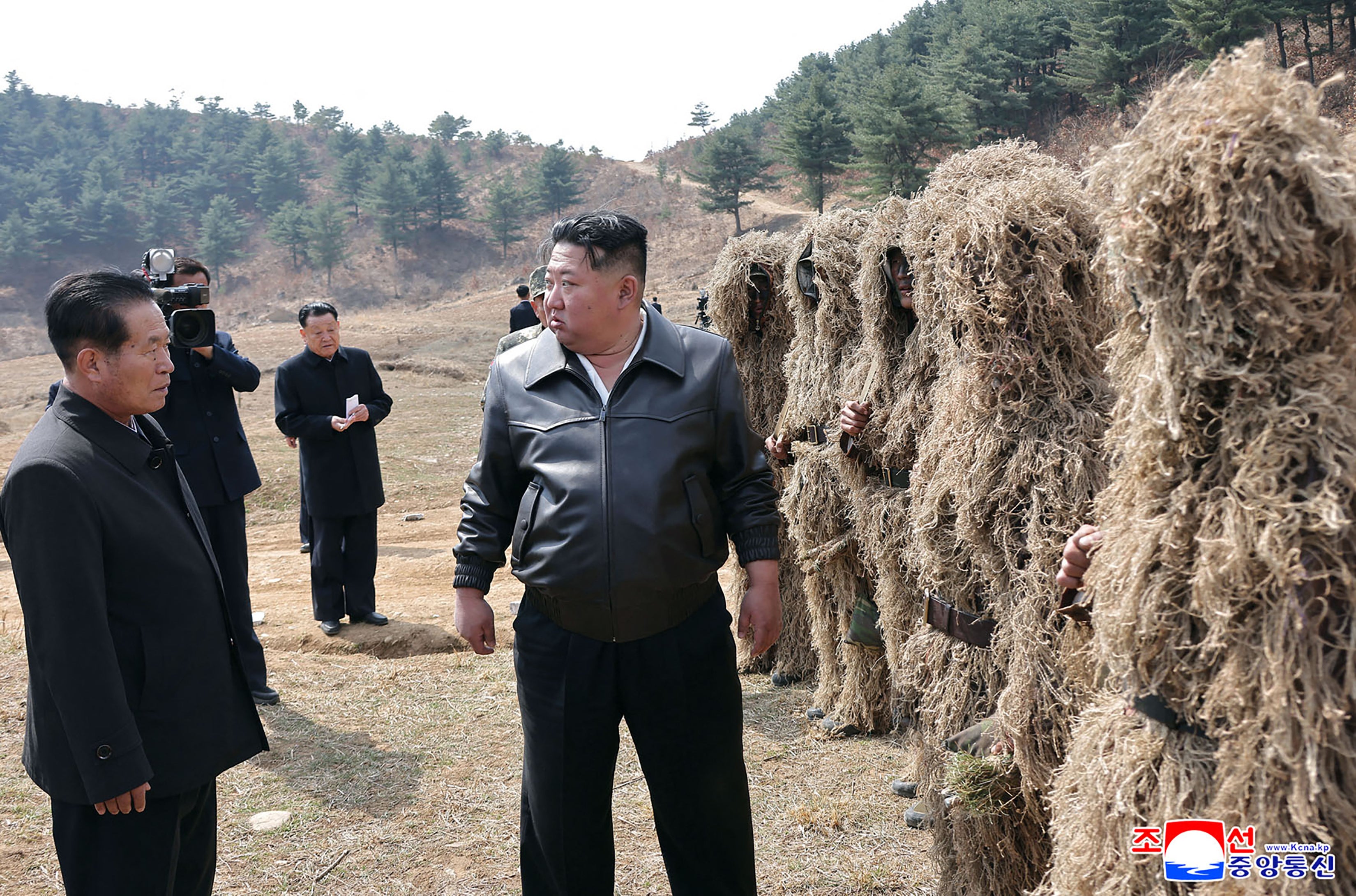 Kim Jong Un interacts with troops at a training base of the Korean People's Army's special operations forces