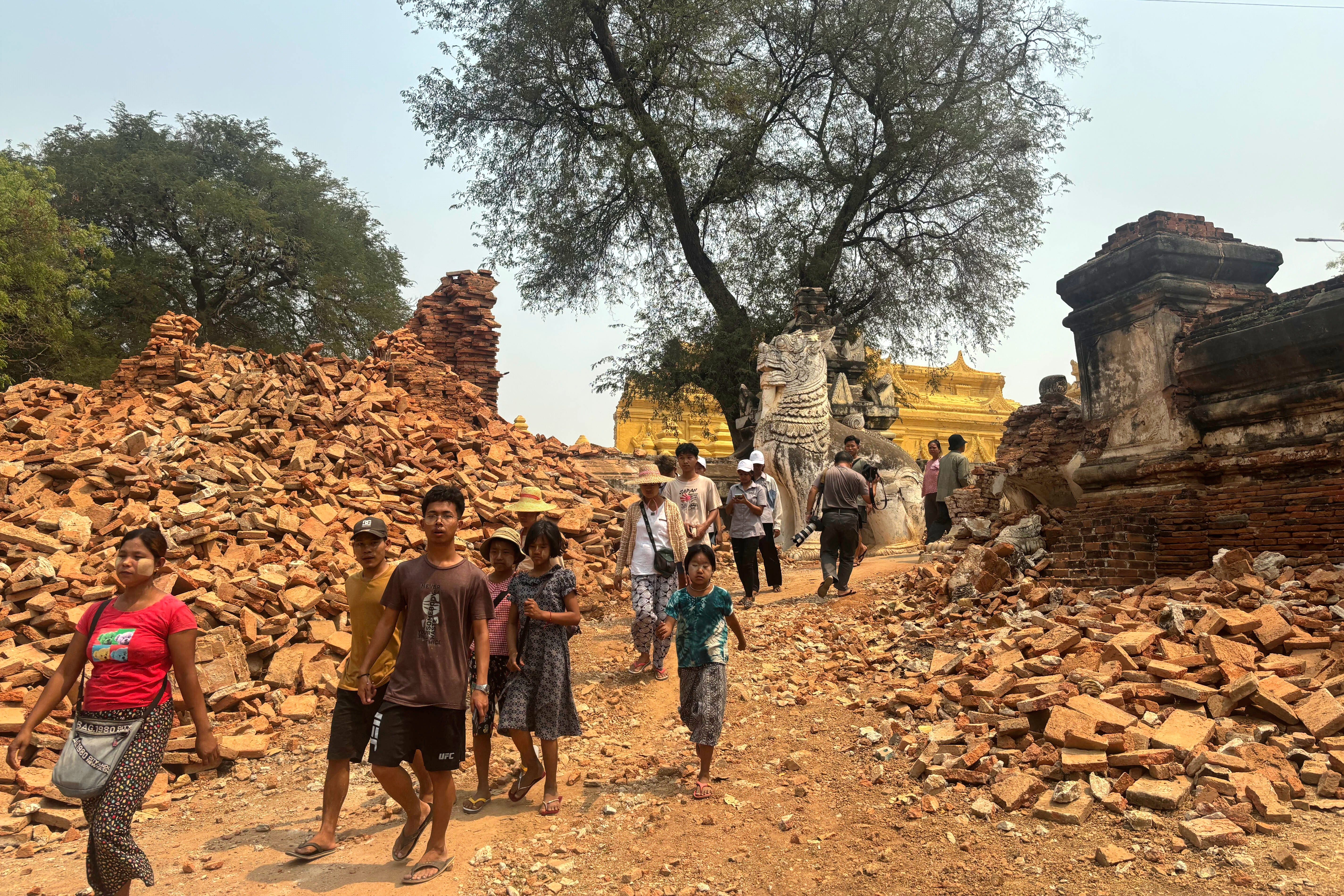 Visitors walk near entrance of Maha Aungmye Bonzan Monastery, commonly known as the Me Nu Brick Monastery, in the aftermath of Friday's earthquake in Innwa, Tada-U township, Mandalay, Myanmar, Friday, April 4, 2025