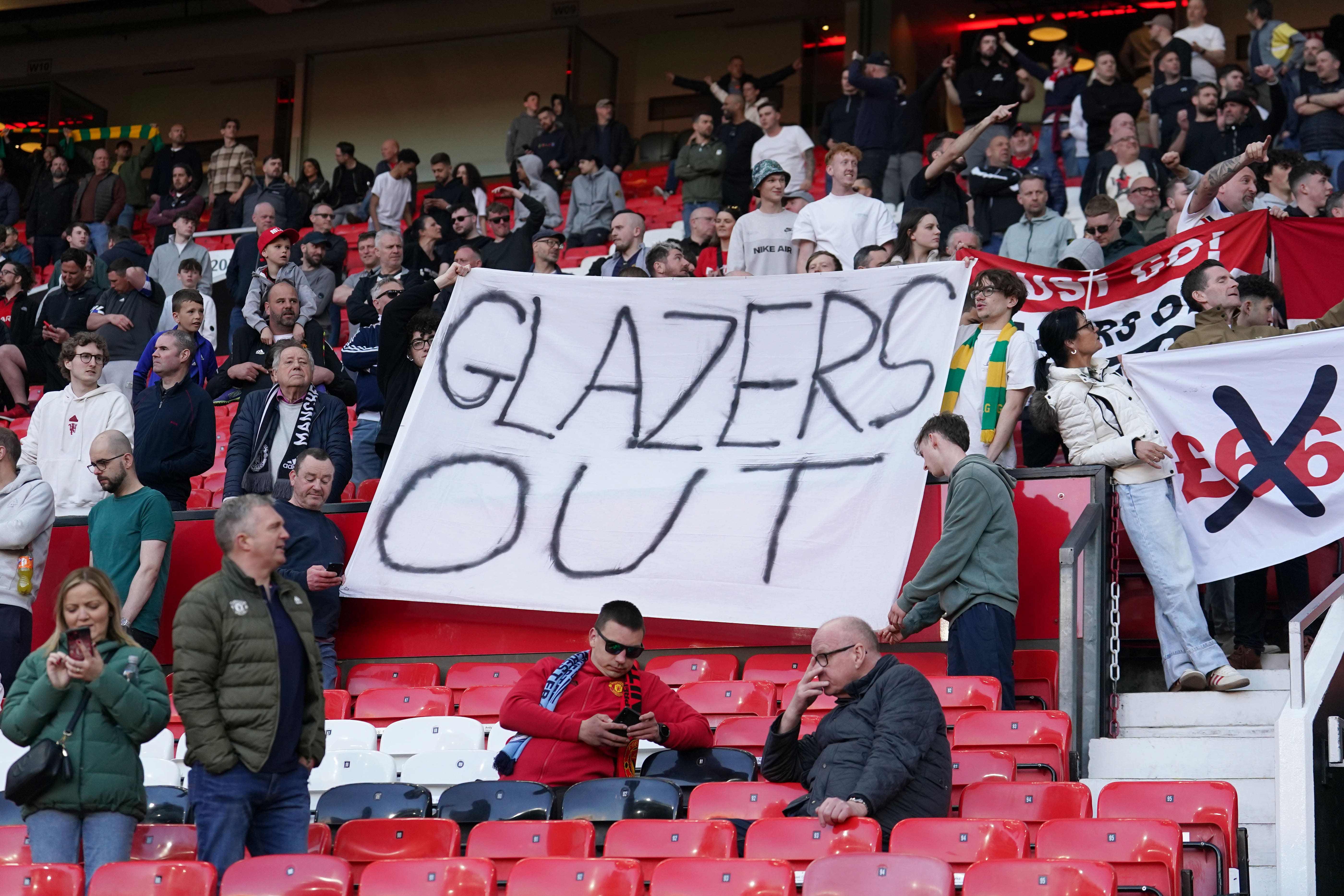 Manchester United fans held up banners (Martin Rickett/PA)