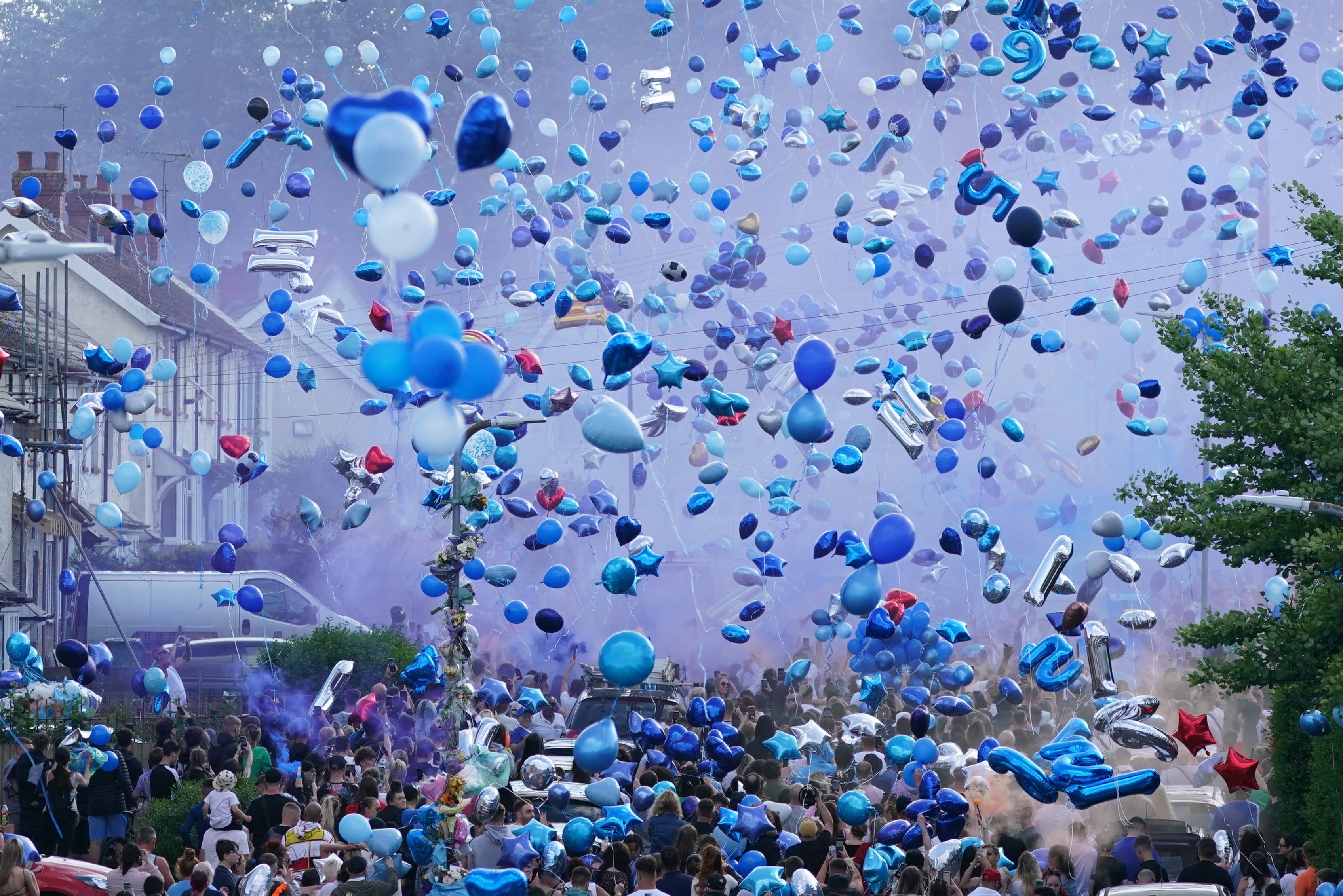 People release balloons during a vigil for the pair