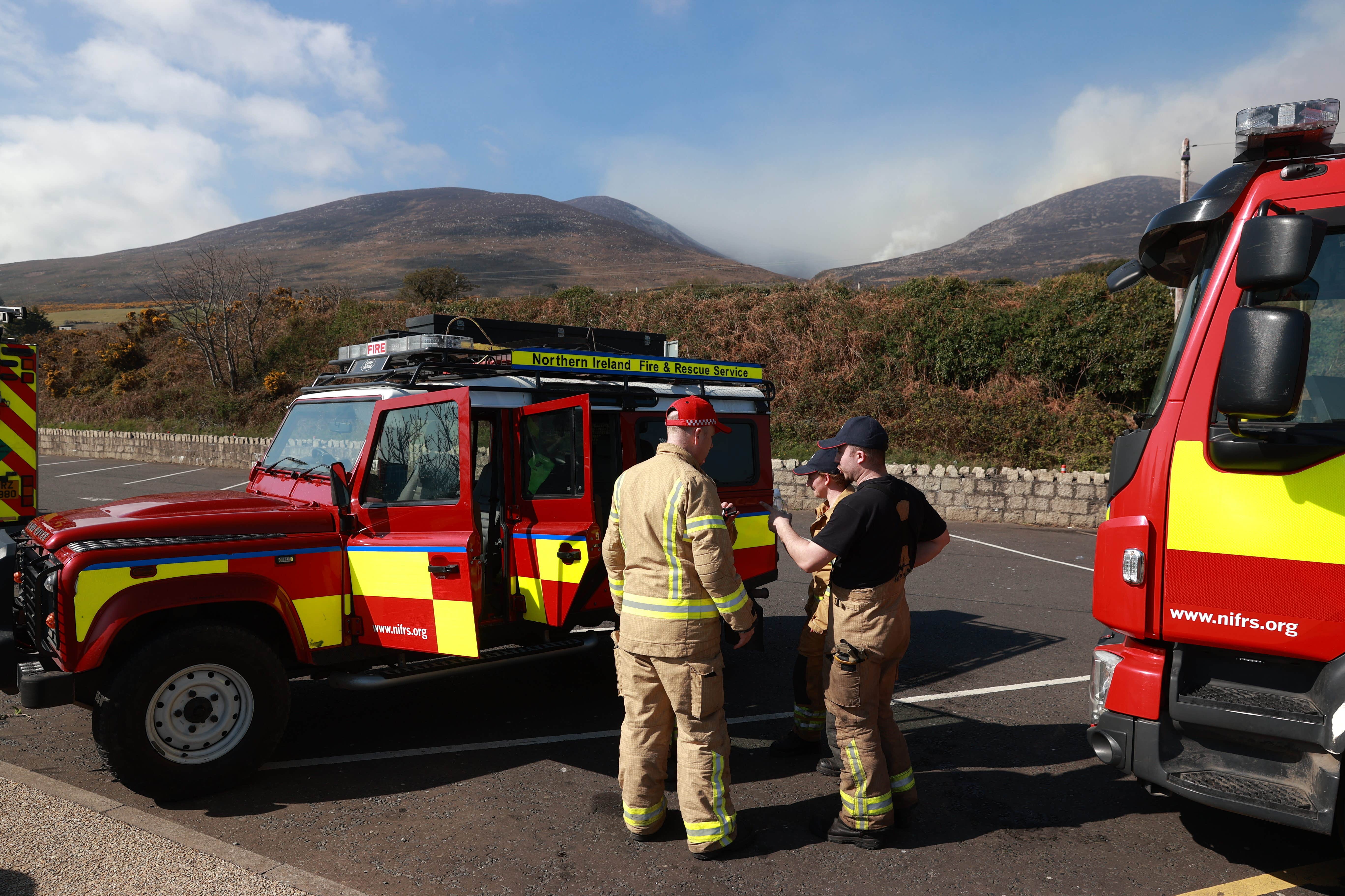 Firefighters from Northern Ireland Fire and Rescue Service at Bloody Bridge car park, Newcastle in Co Down, preparing to tackle gorse fires on the Mourne Mountains (Liam McBurney/PA)