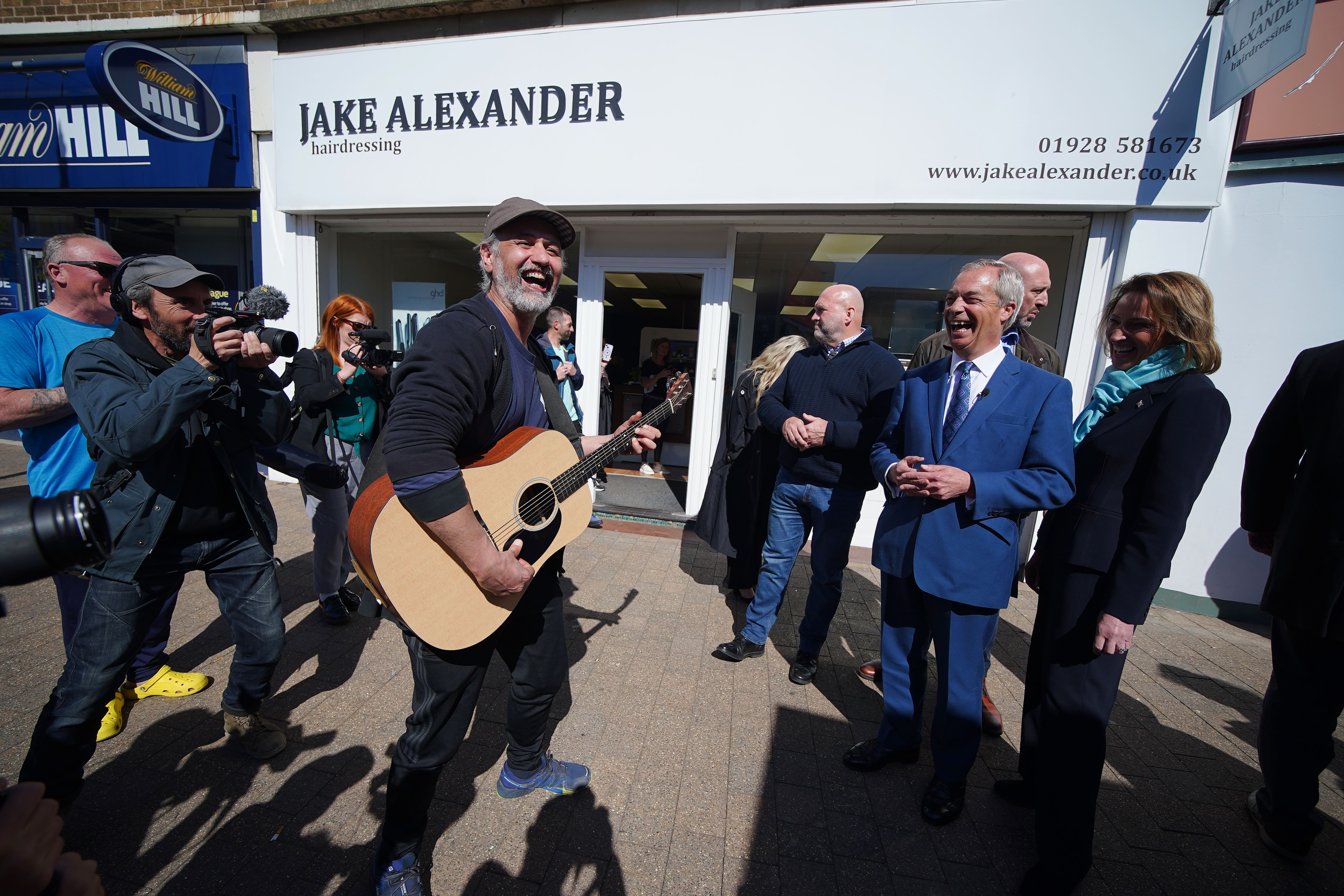 Reform UK leader Nigel Farage with his party’s candidate Sarah Pochin during a walkabout on Runcorn High Street (Peter Byrne/PA)