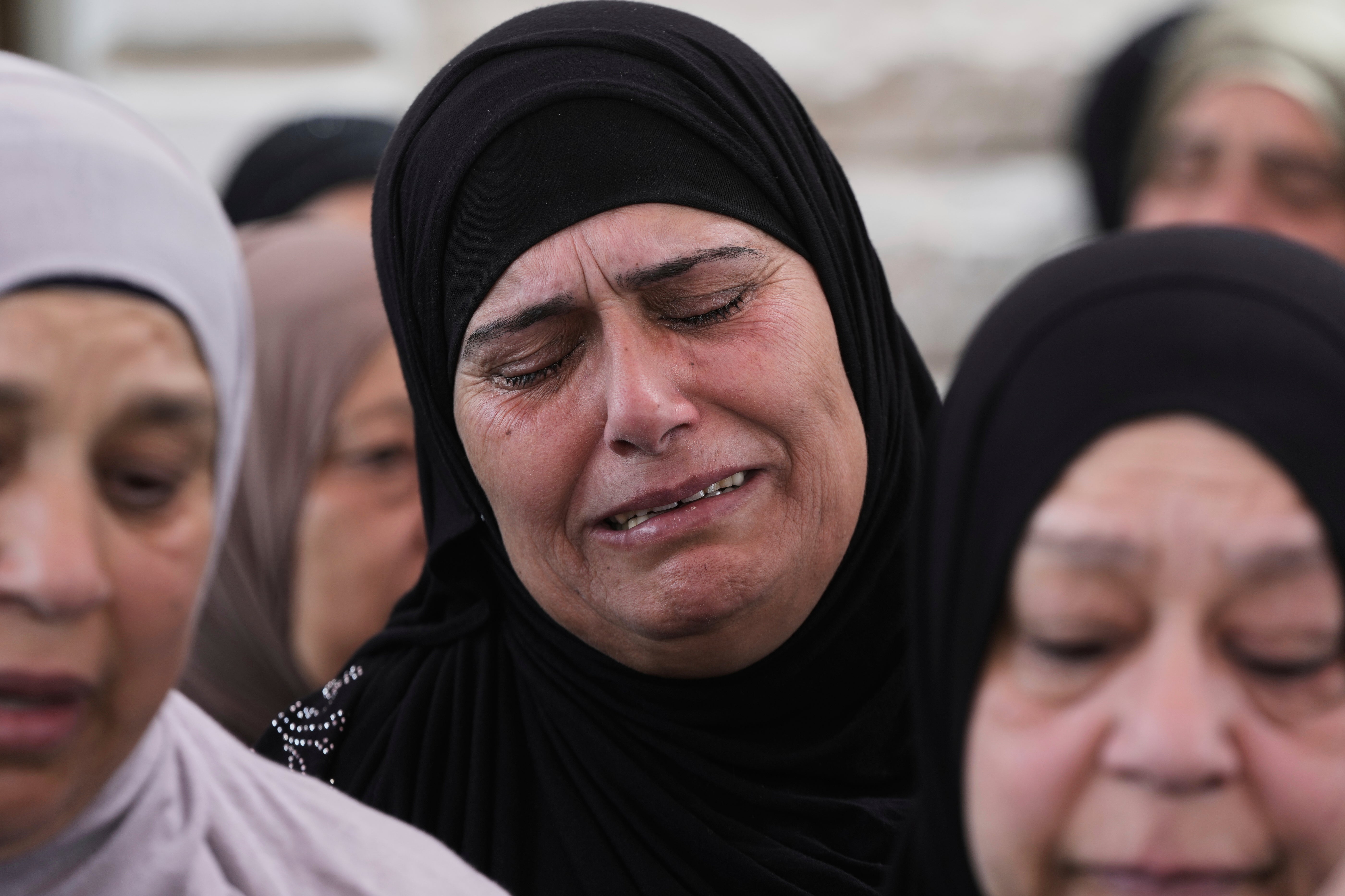 A woman weeps at the funeral of Amer Mohammed Rabee