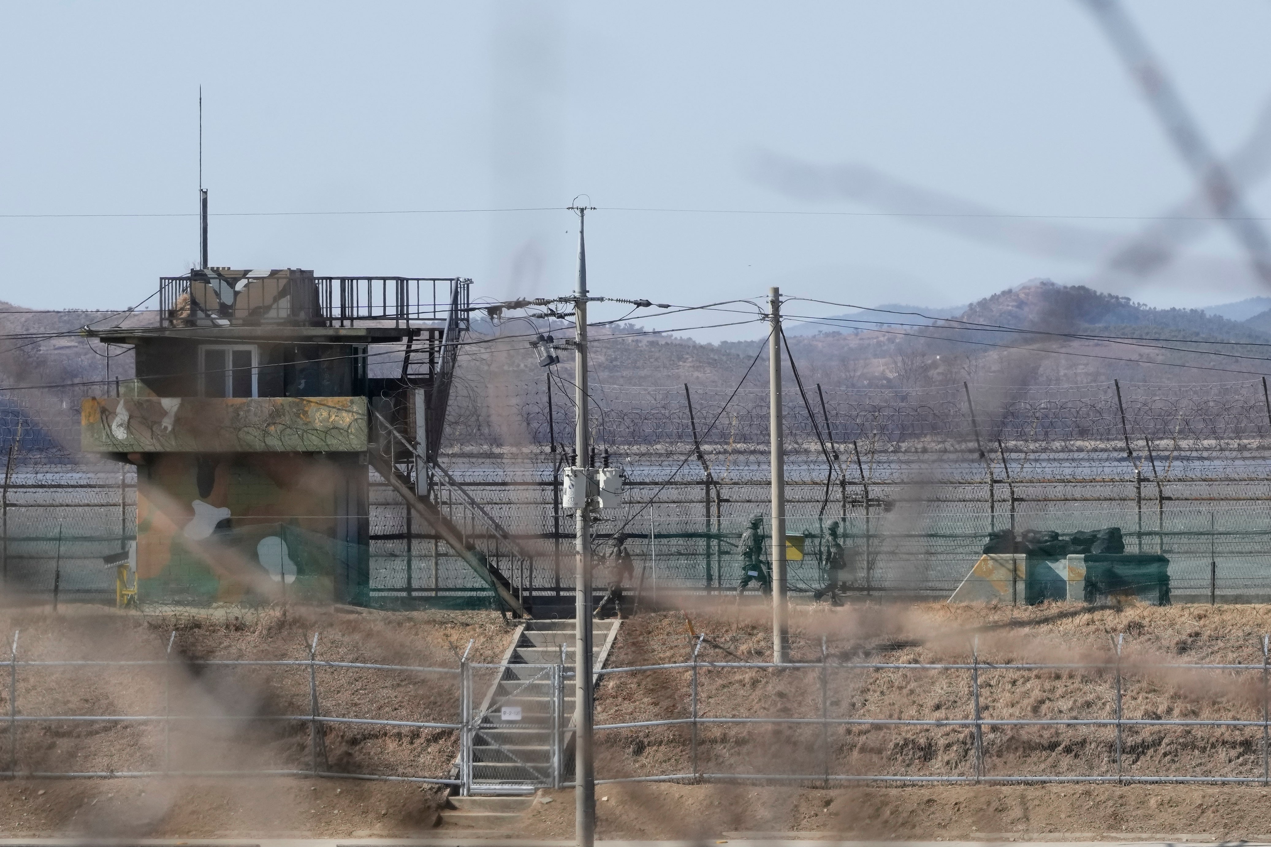 South Korean army soldiers patrol along the barbed-wire fence in Paju, South Korea, near the border with North Korea