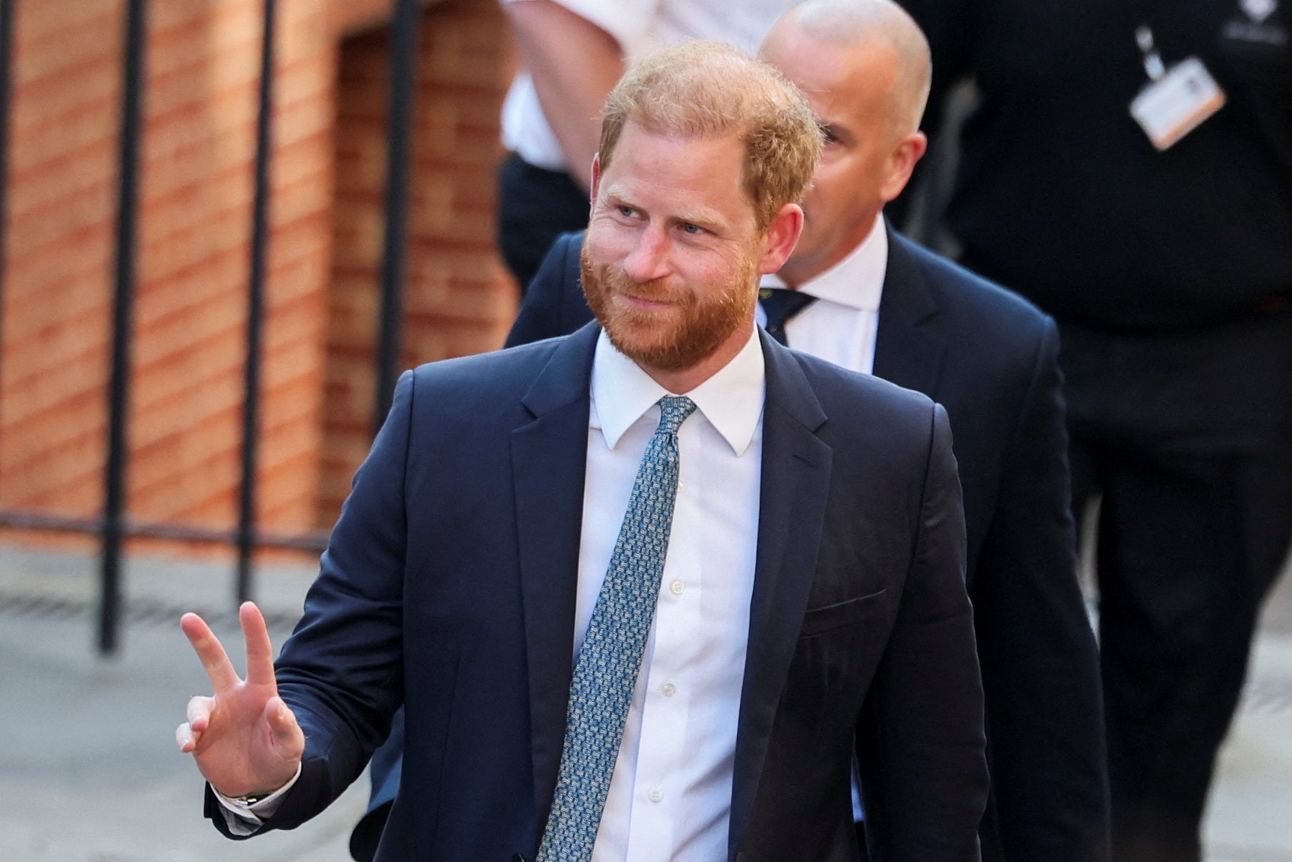 Prince Harry waves as he entered the Royal Courts of Justice