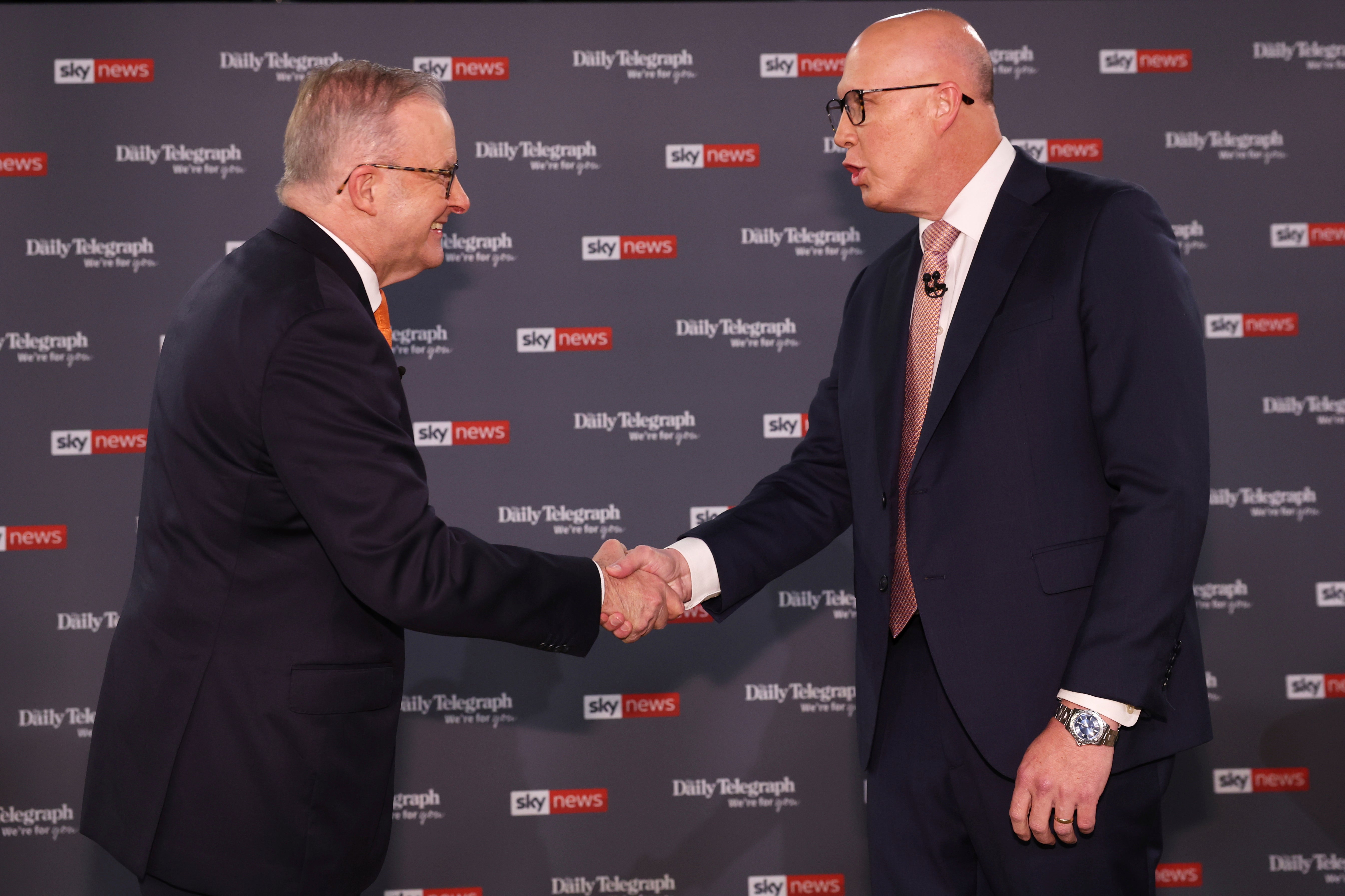 Australian Prime Minister Anthony Albanese, left, shakes hands with Opposition leader Peter Dutton ahead of their TV debate in Sydney