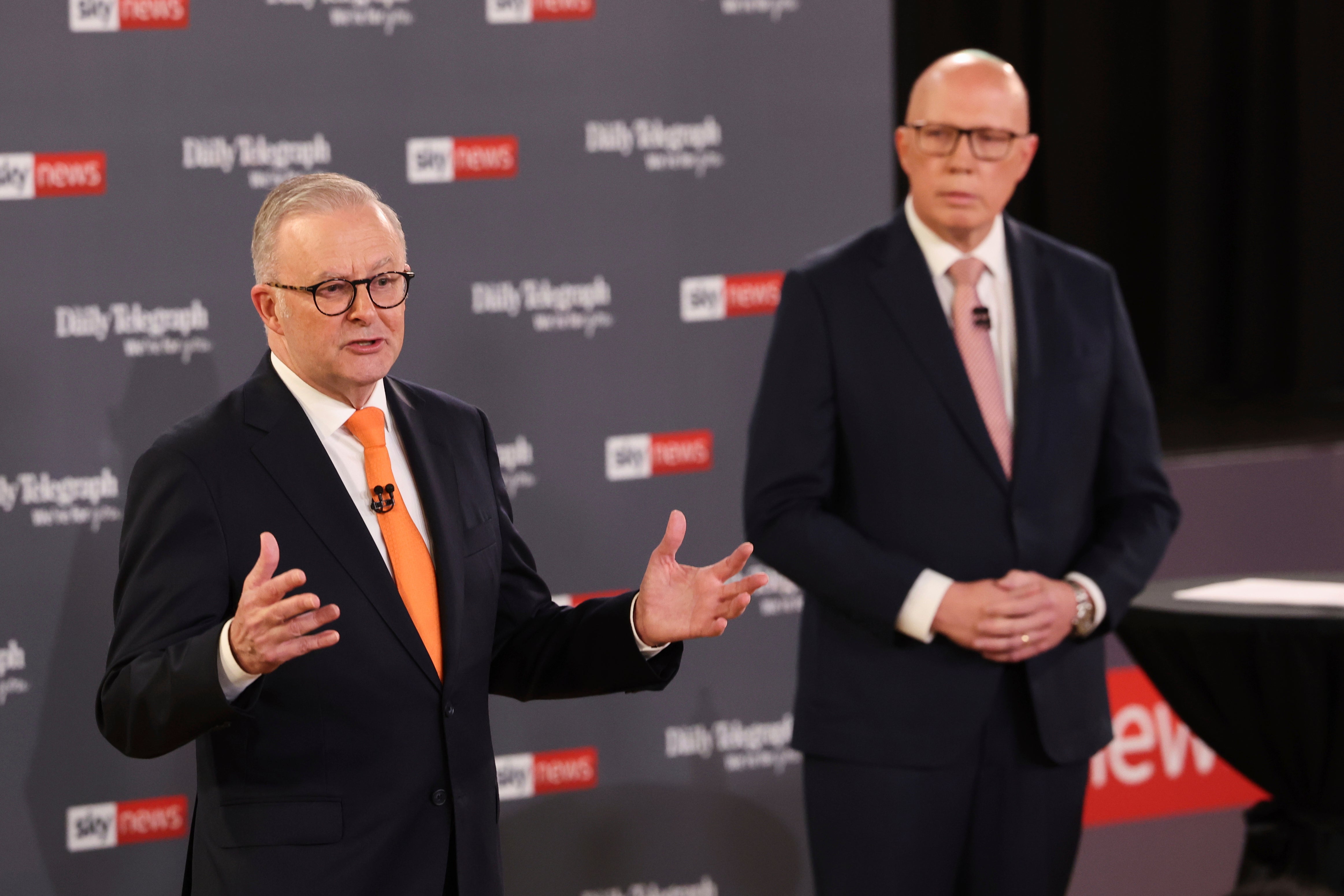 Australian Prime Minister Anthony Albanese, left, gestures as Opposition leader Peter Dutton watches during their TV debate in Sydney, Australia, Tuesday, April 8, 2025. (Jason Edwards/Pool Photo via AP)
