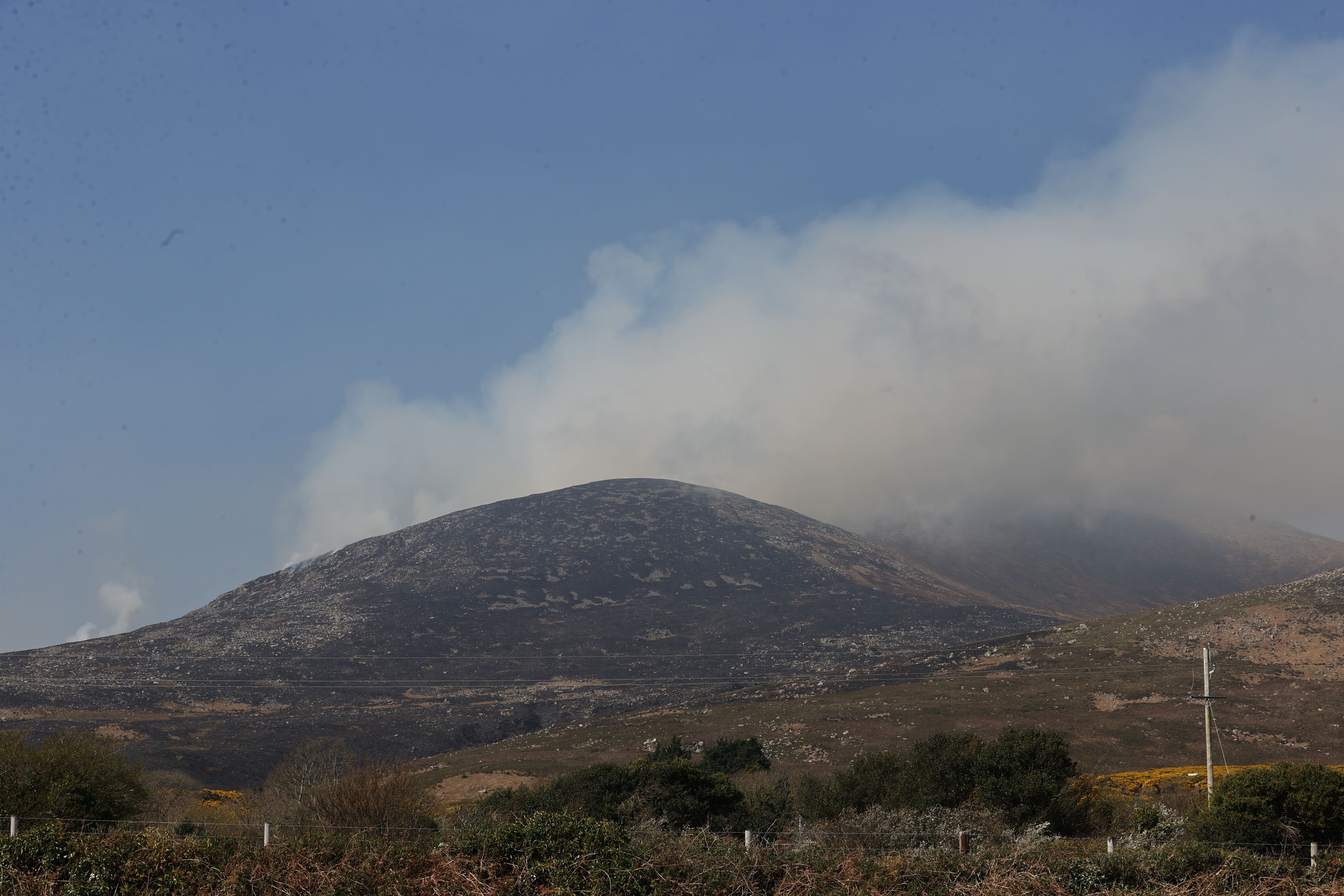 Smoke over the Mourne Mountains in Co Down. Firefighters have tackled almost 150 wildfires in Northern Ireland across three days, a commander has said. Group commander Danny Ard from the Northern Ireland Fire and Rescue Service said a “significant majority” of the fires were started deliberately. Picture date: Monday April 7, 2025.