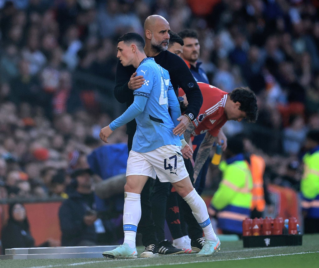 Pep Guardiola embraced Phil Foden as he was substituted during the Manchester derby, when the offensive chants took place