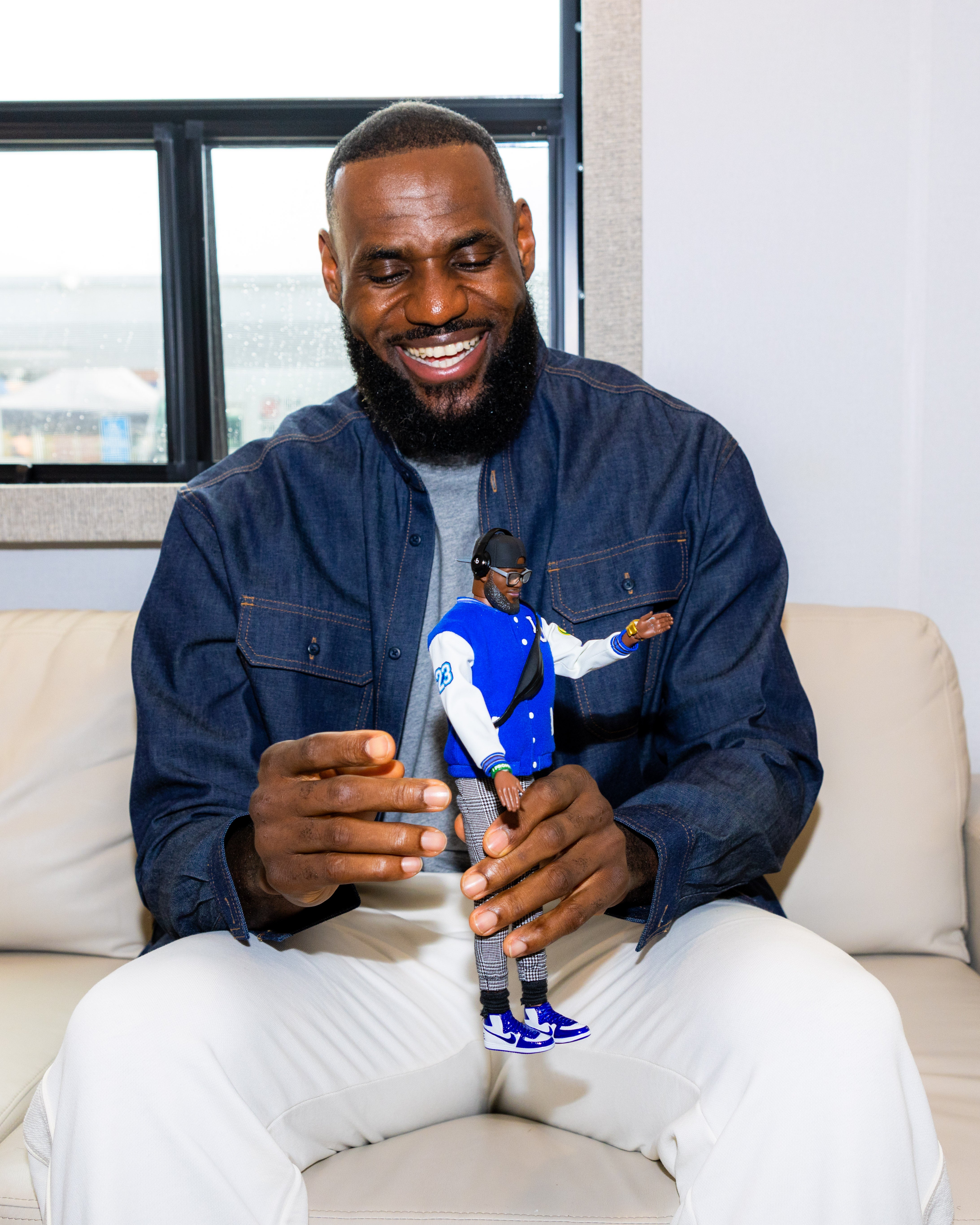 LeBron James with the LeBron James Kenbassador doll