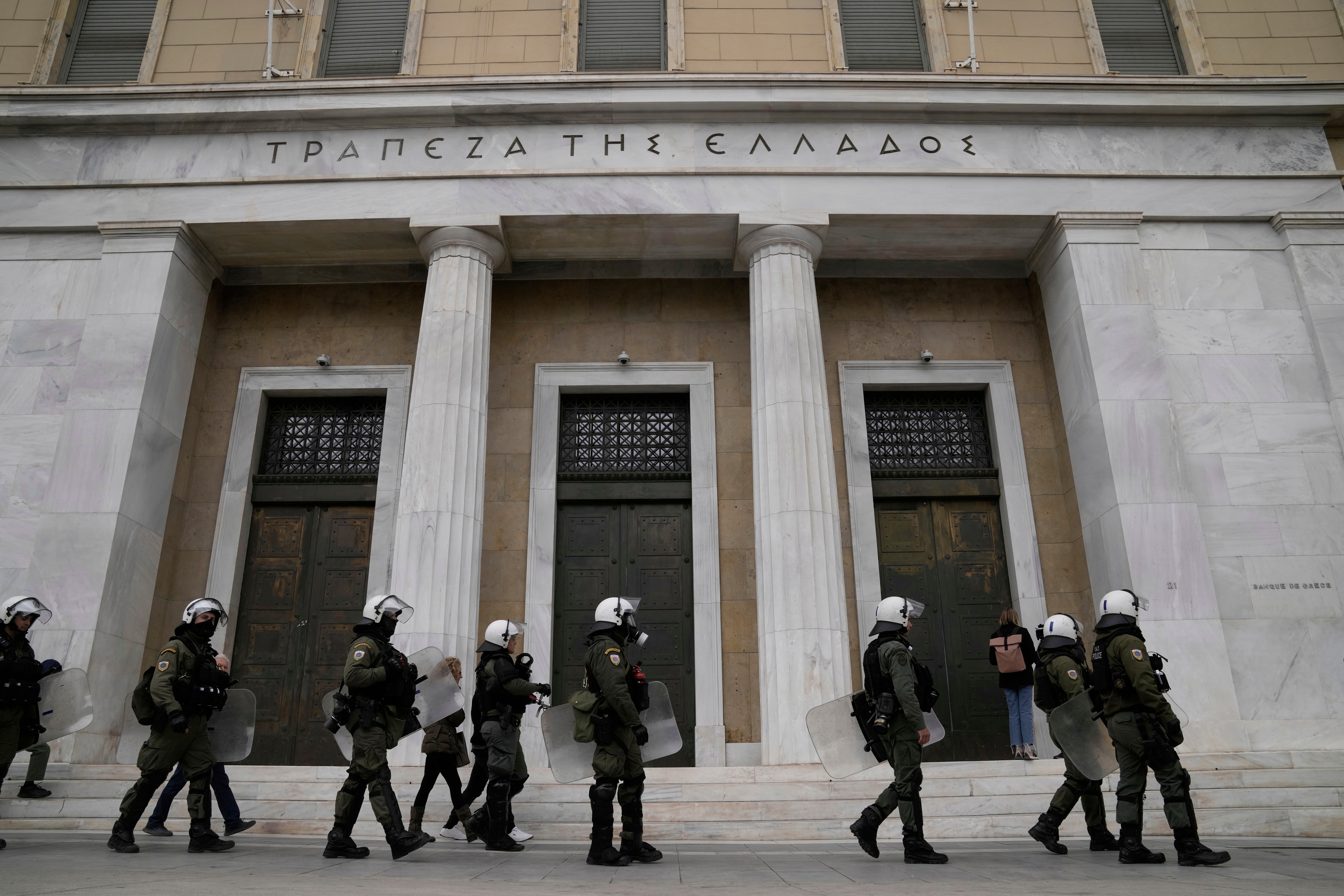 Riot police walk in front of the headquarters of the Bank of Greece during a nationwide 24-hour strike last week