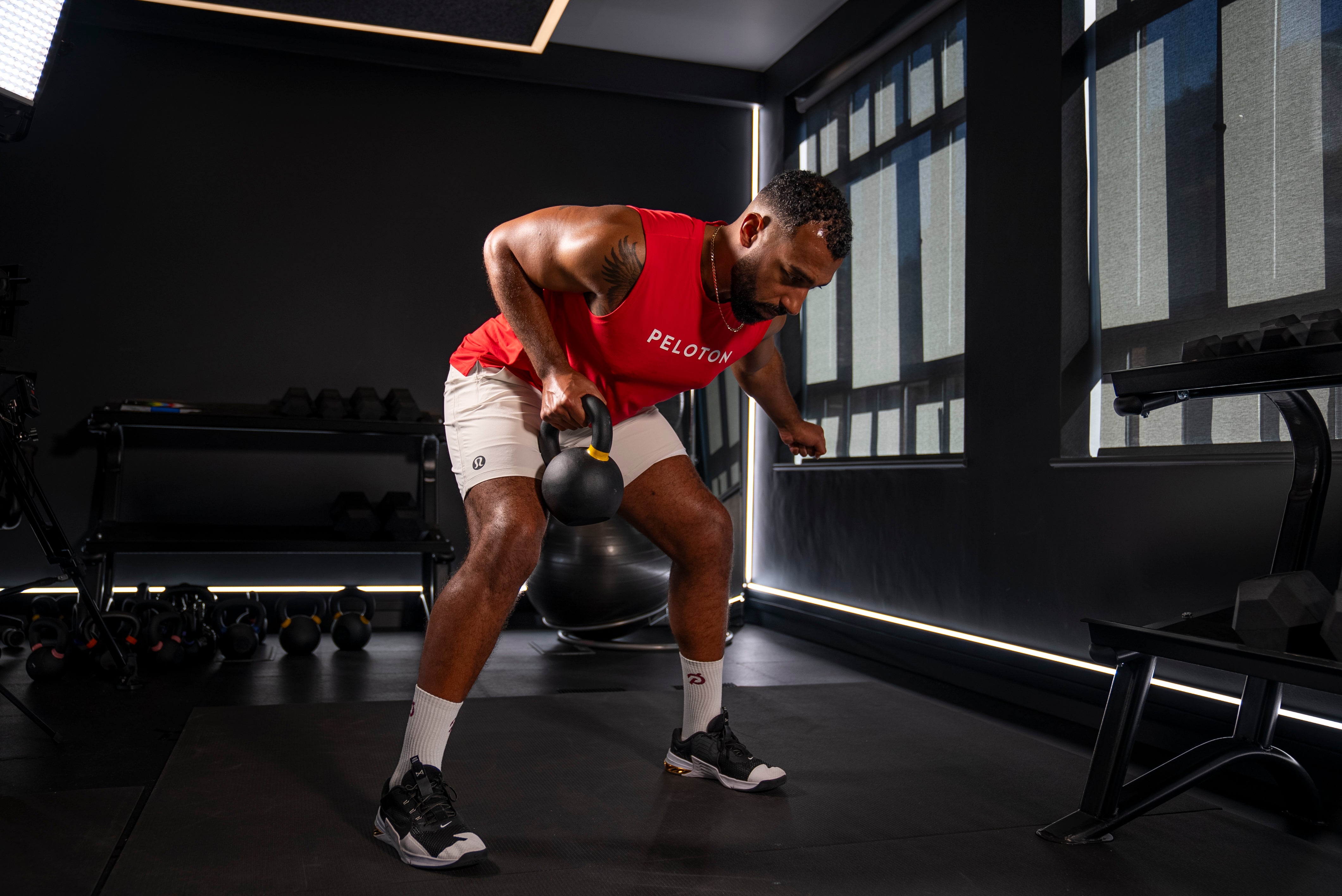 Peloton instructor Jermaine Johnson demonstrating a single-arm row