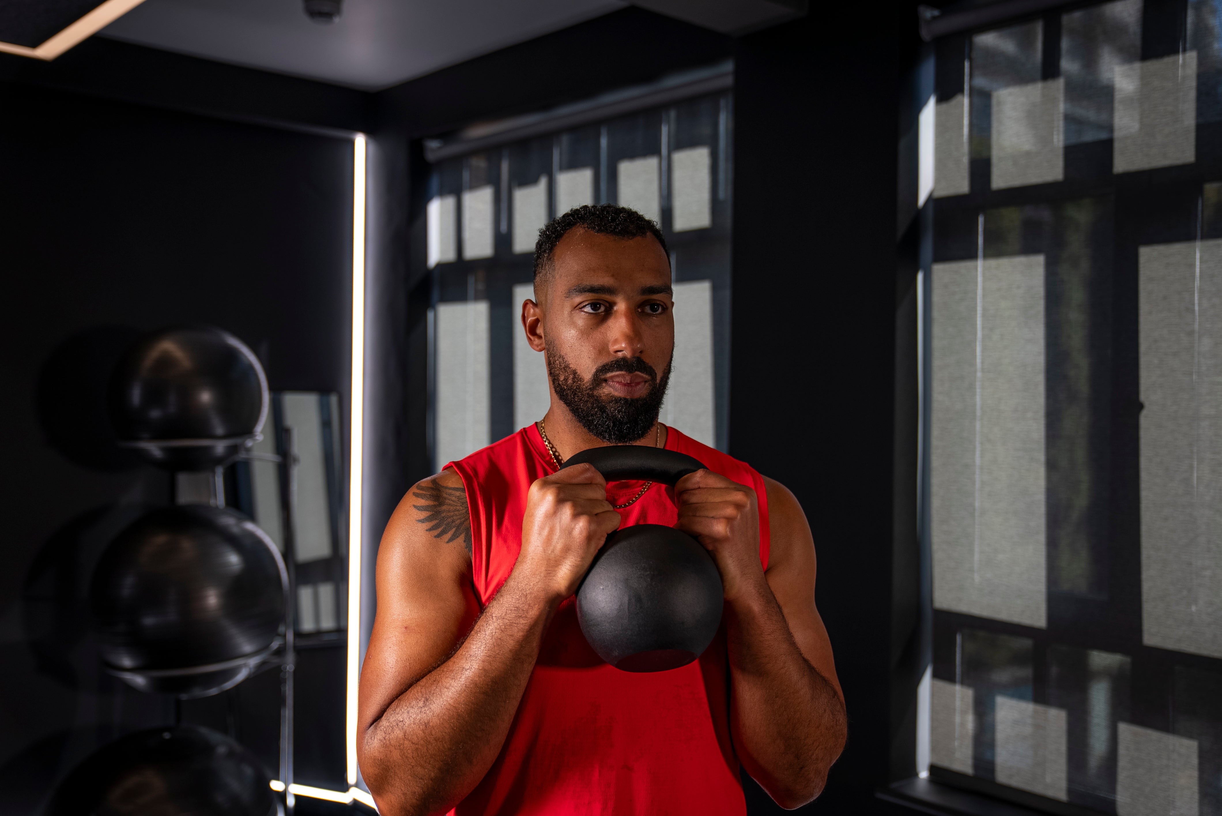 Peloton instructor Jermaine Johnson demonstrating a front squat