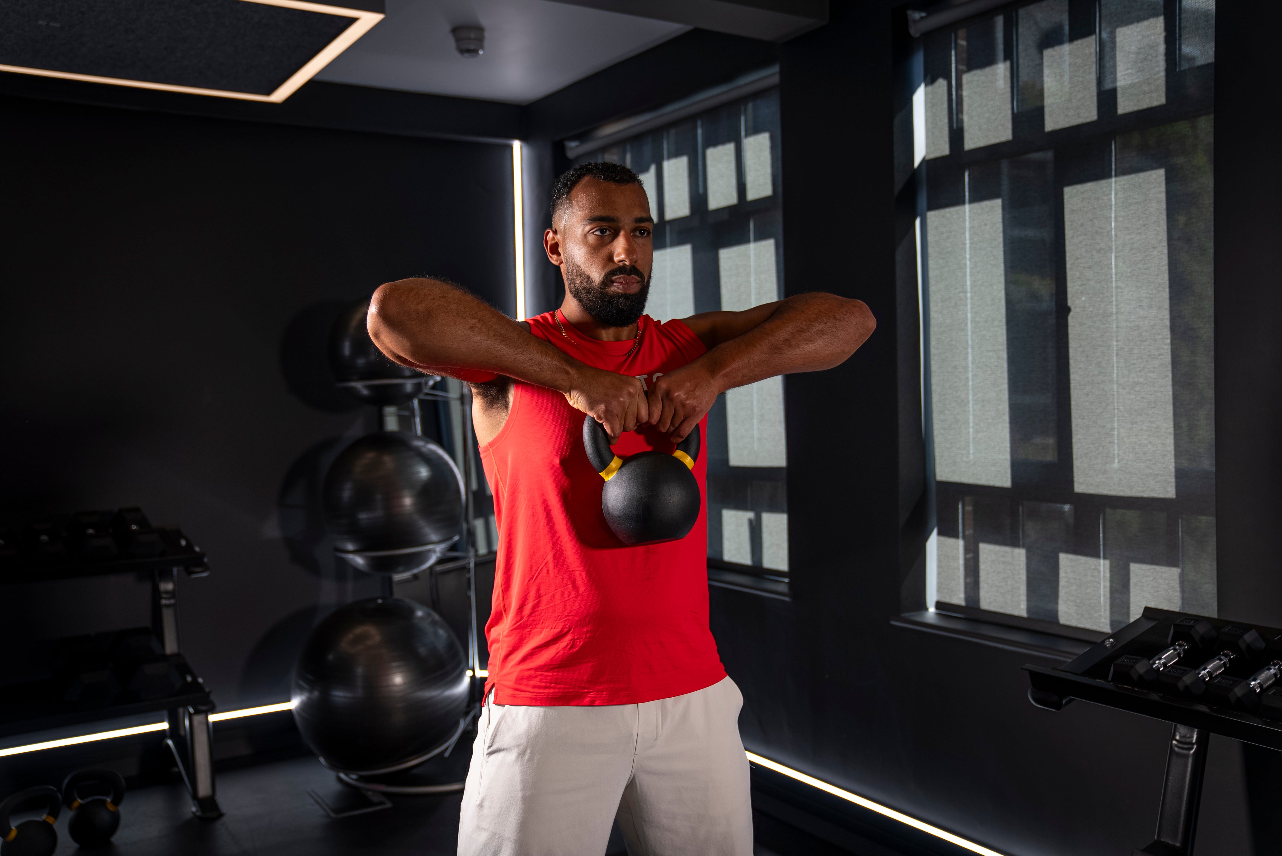 Peloton instructor Jermaine Johnson demonstrating a deadlift to high pull