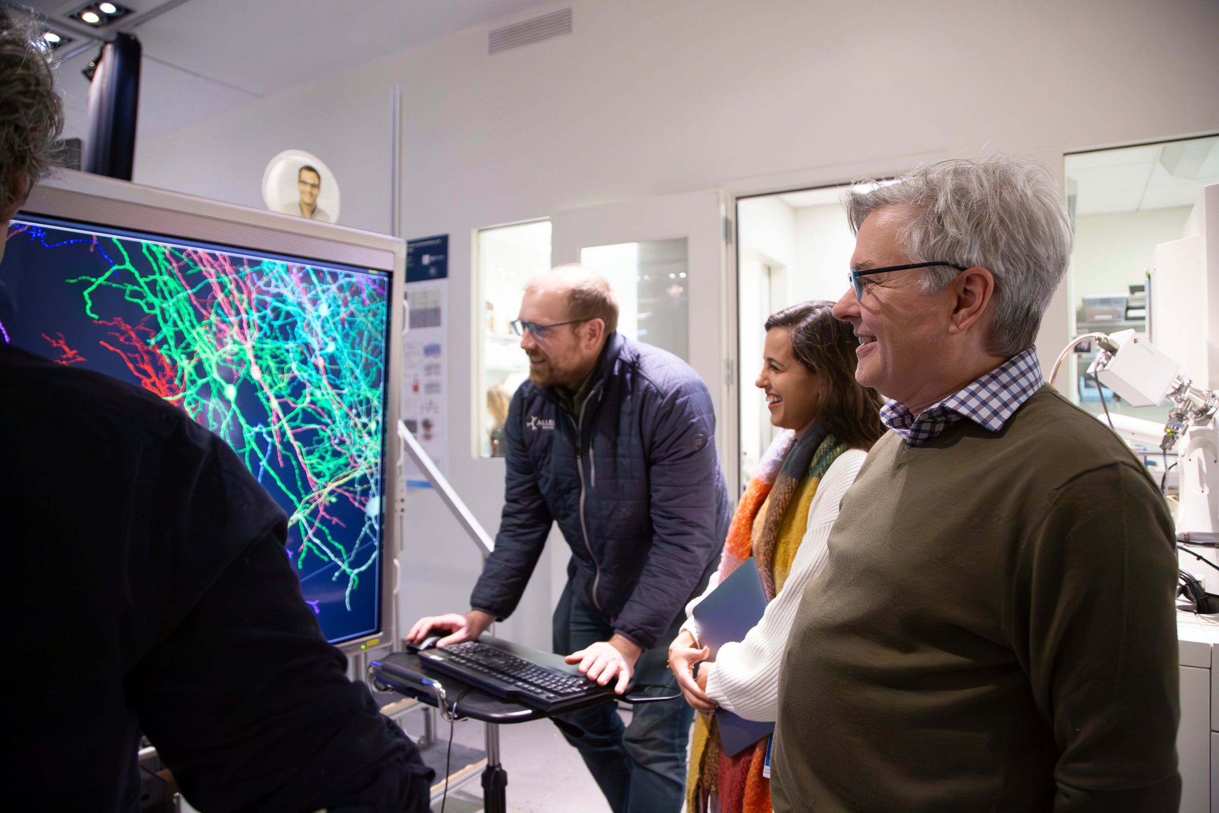 This photo provided by the Allen Institute shows, from left, Associate Director of Informatics Forrest Collman, Data Analyst Leila Elabbady and Senior Investigator Clay Reid reviewing neuron reconstructions for the Machine Intelligence from Cortical Networks project in Dec. 2024, in Seattle, Wash. (Jenny Burns/Allen Institute via AP)