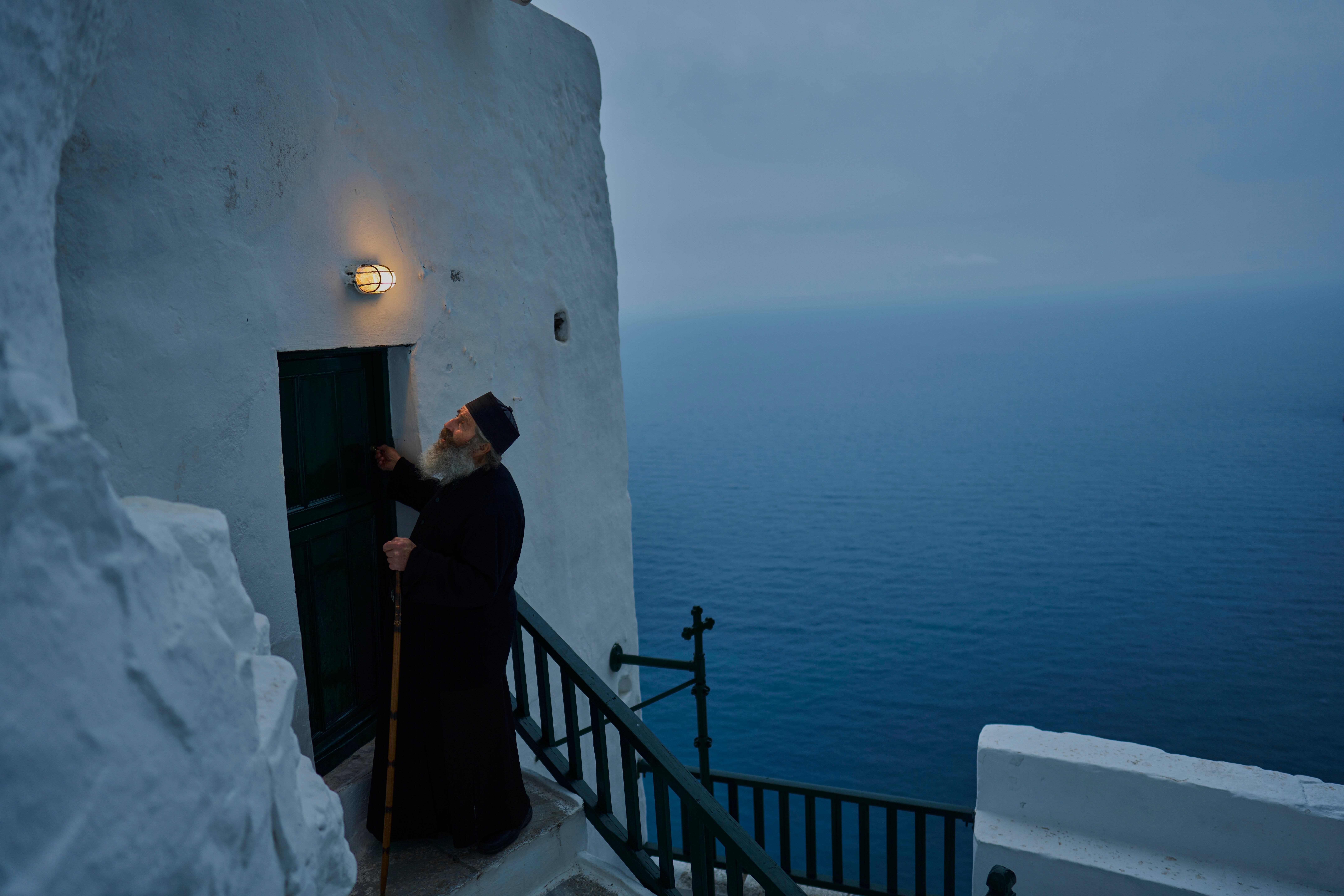 Orthodox Christian monk Father Spyridon locks the chapel of the Monastery of Panagia Hozoviotissa