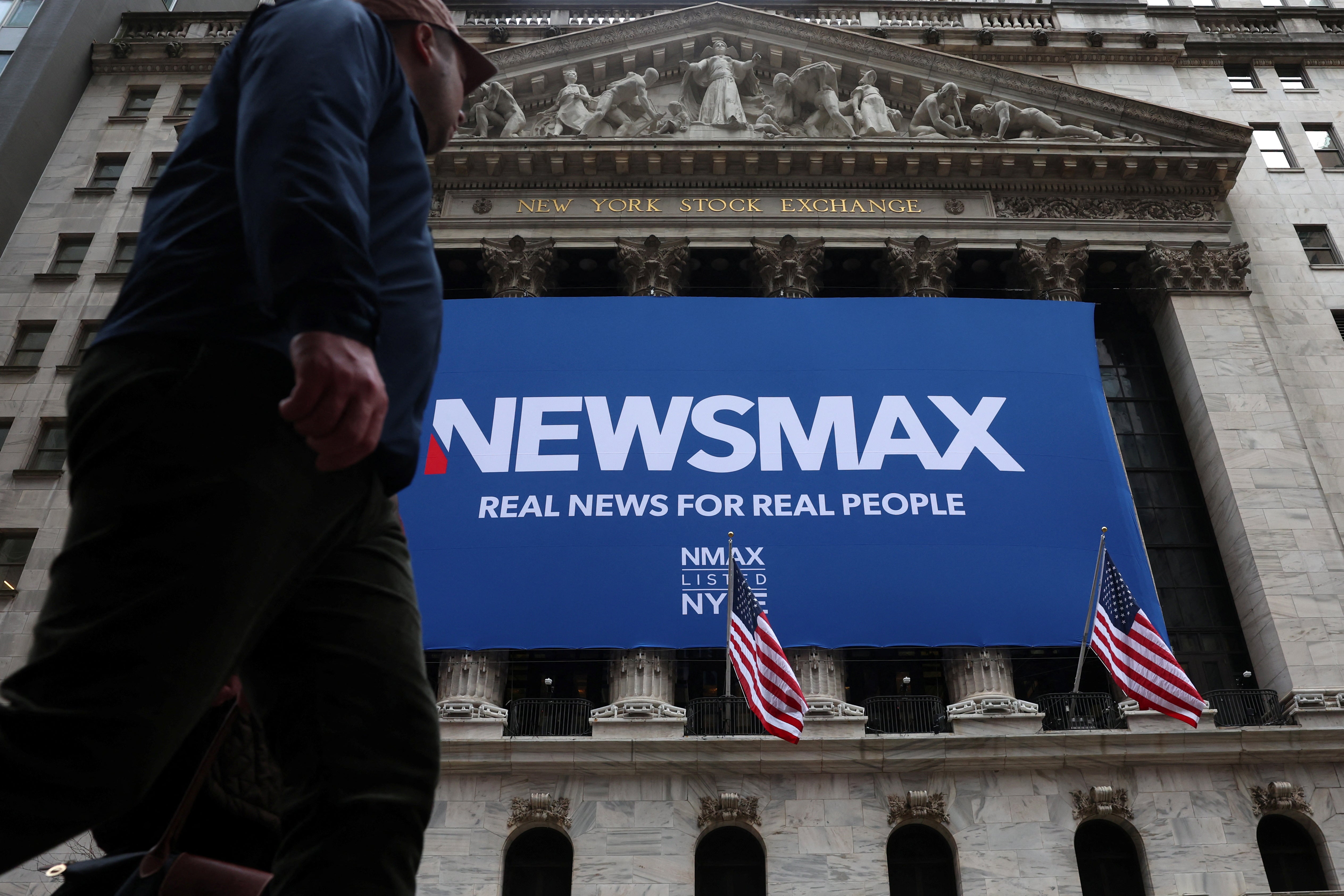 A banner for Newsmax Inc. is displayed during the company's IPO at the New York Stock Exchange