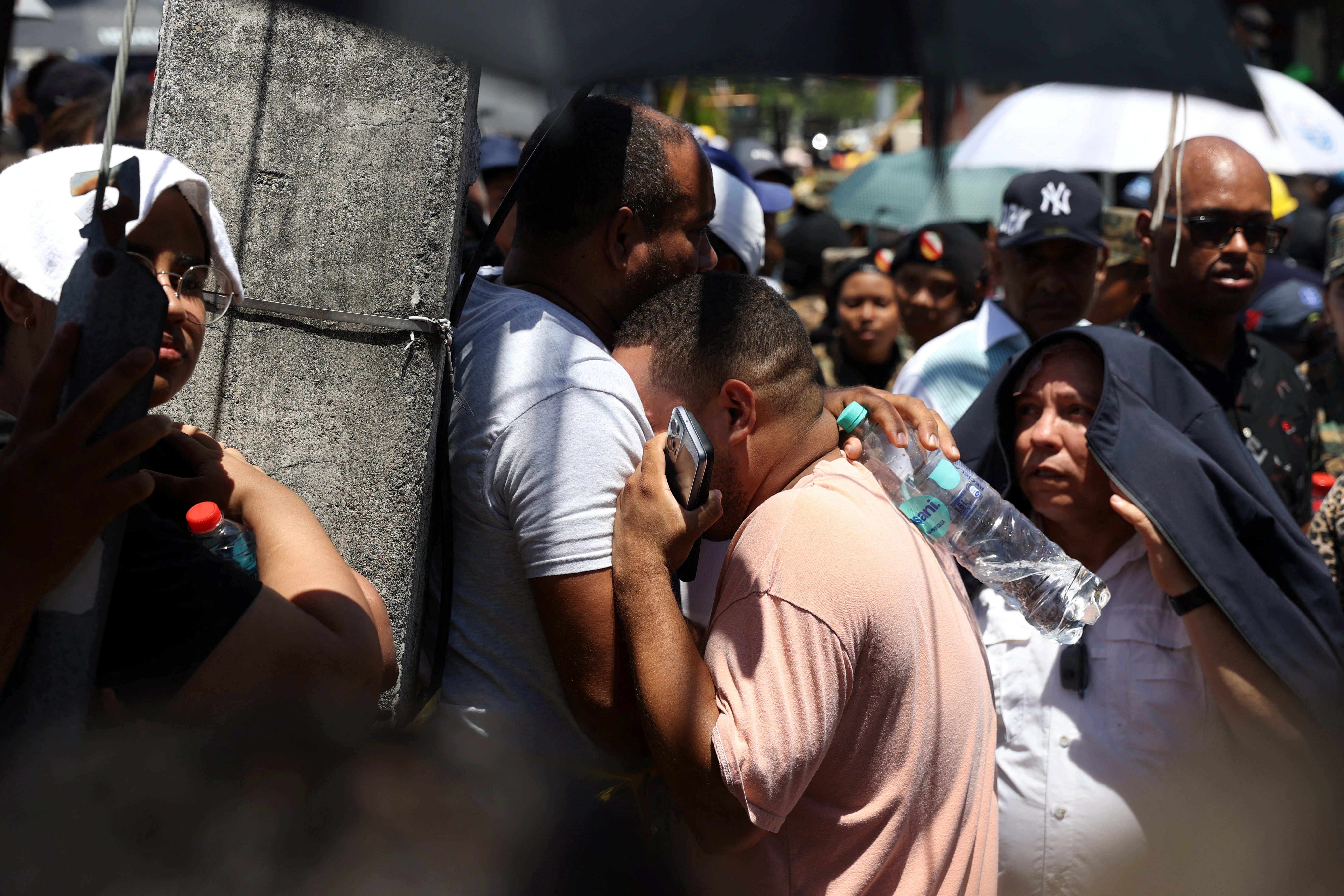 Relatives of victims react at the site of the collapsed Jet Set nightclub in Santo Domingo