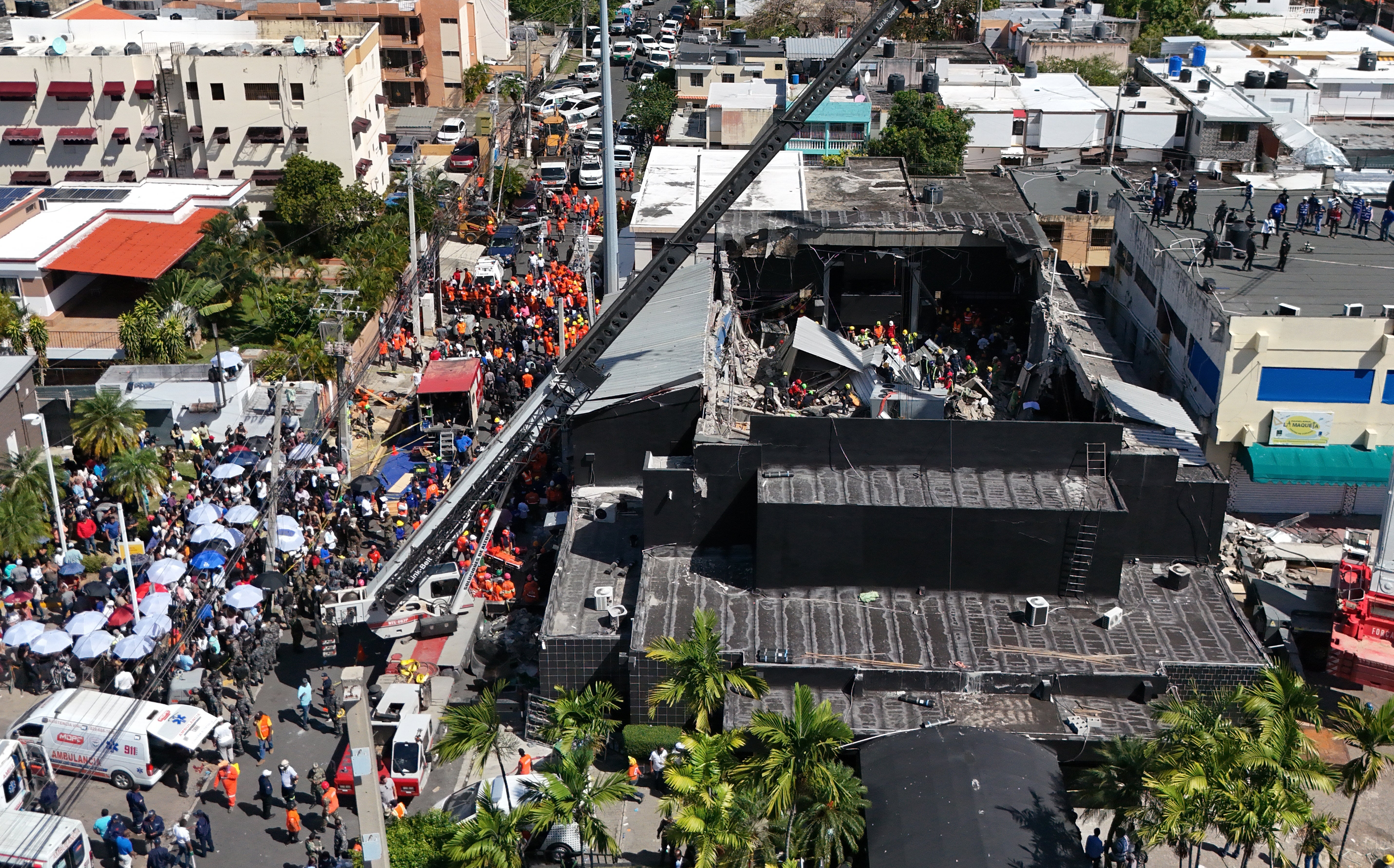 Members of the fire and rescue services work at the scene after the collapse of the Jet Set Club's roof in Santo Domingo, Dominican Republic