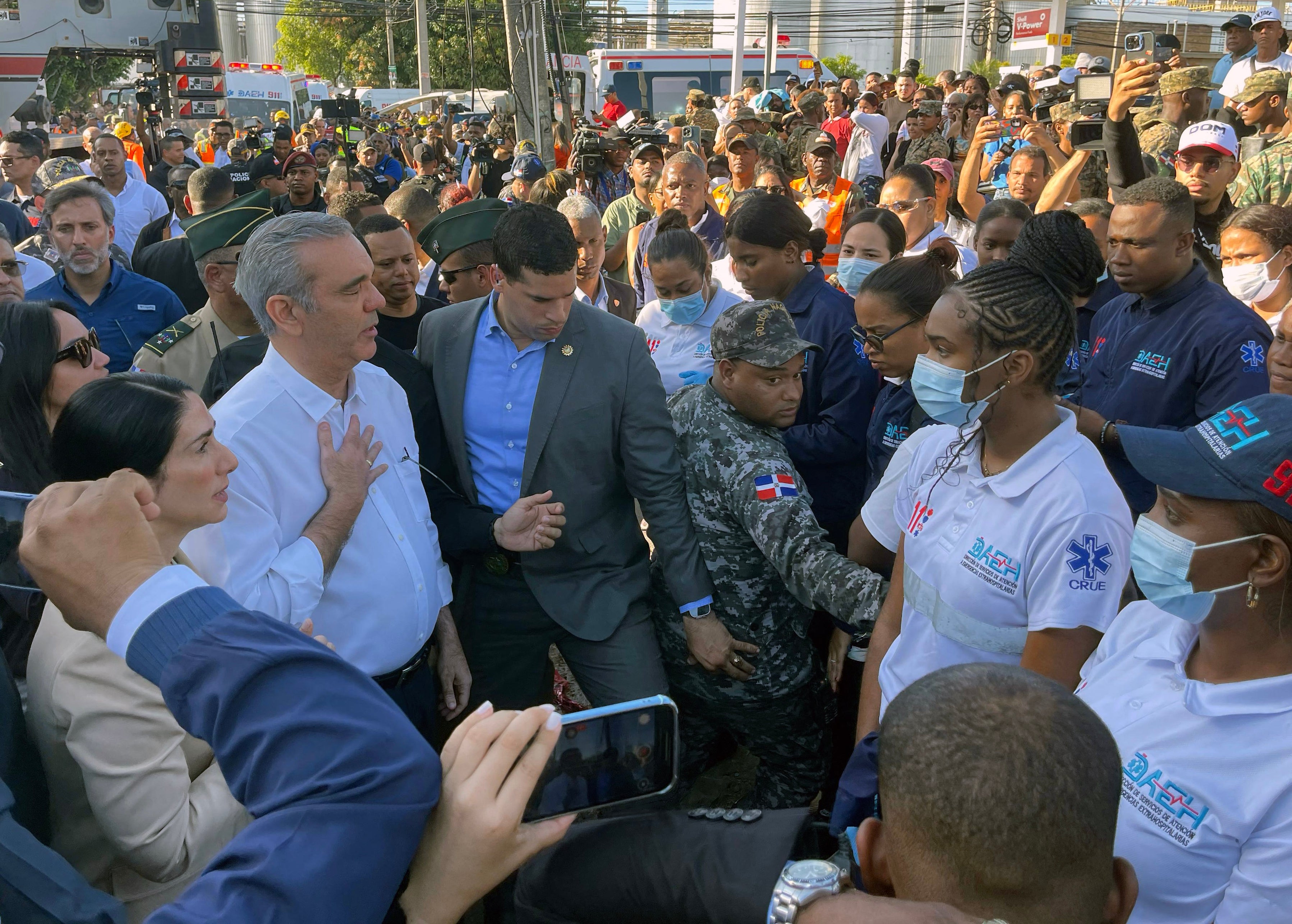 Dominican president Luis Abinader, left, gestures in front of the Jet Set nightclub following the collapse of its roof in Santo Domingo
